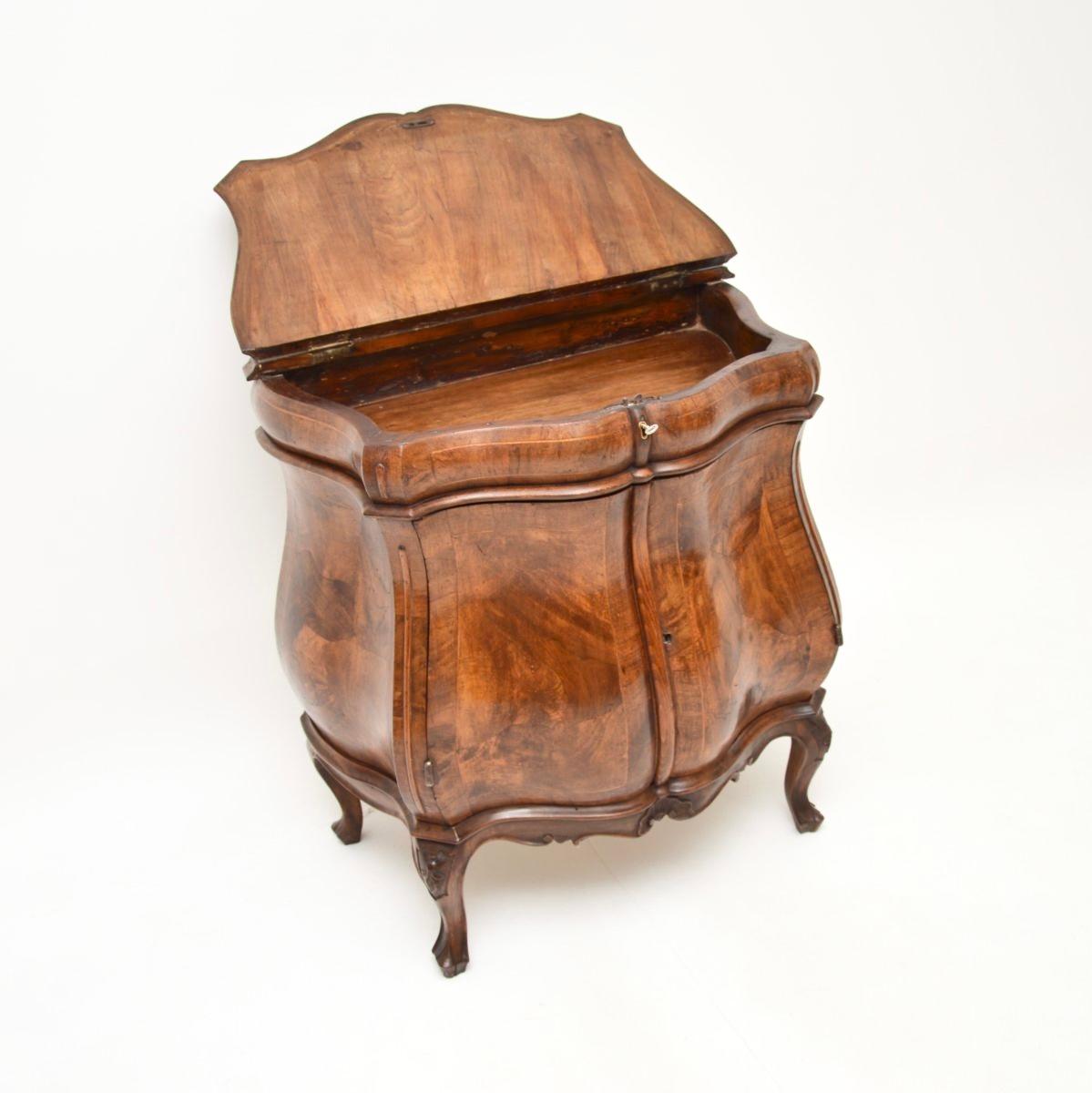 A stunning antique Italian inlaid walnut bombe cabinet, dating from around the 1870-1890 period.

This is of fantastic quality and has a gorgeous design. It is constructed on solid walnut, with an amazing inlaid patchwork of veneered solid walnut
