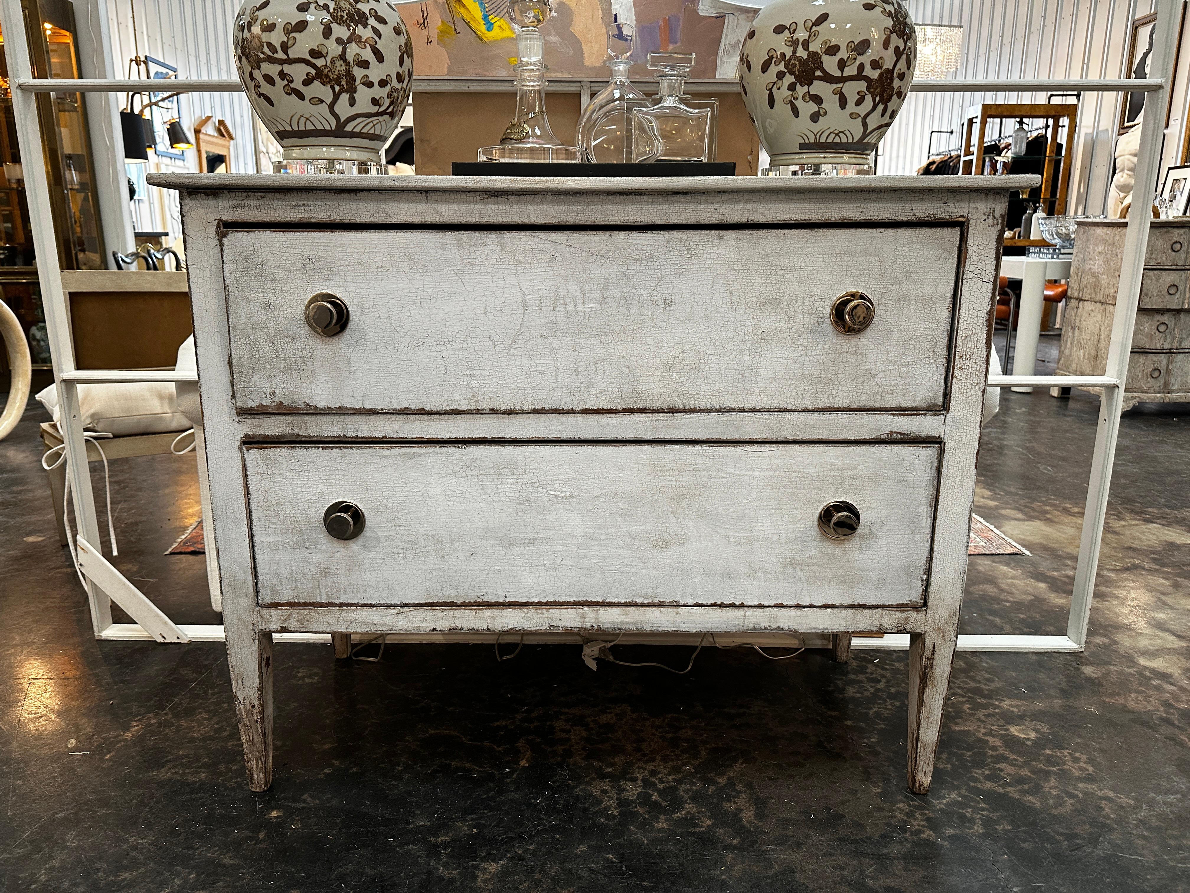 Antique Italian painted chest from early 1900s.  The hardware has been updated with large knurled nickel knobs.   The piece sits on tapered legs, typical of that period of time. The finish is possibly not original (not sure) but is still old.