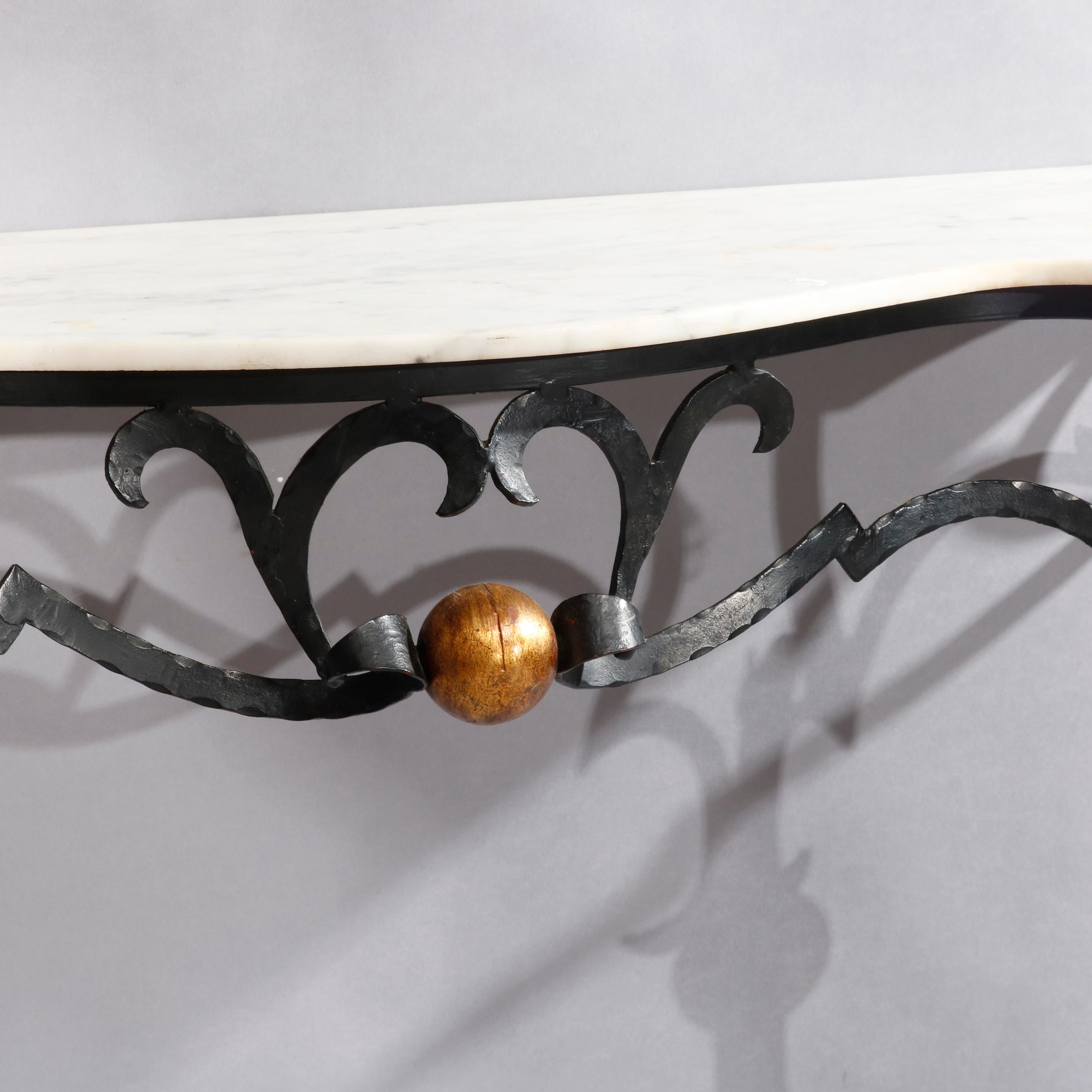 An antique Italian console table offers shaped marble top surmounting scroll form wrought iron base having spherical gilt elements, 20th century

Measures: 32.5