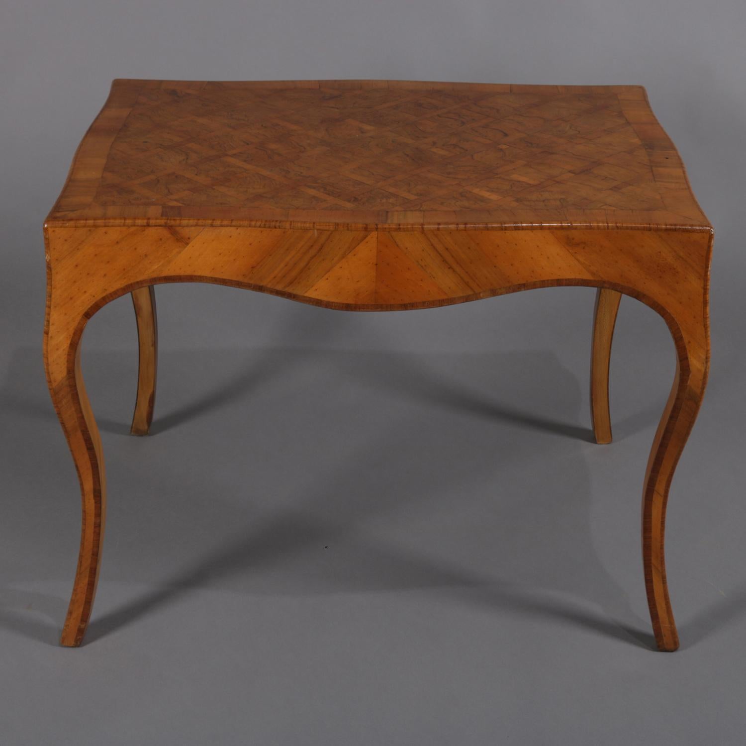 Antique Italian low centre table features mahogany construction with simple and curvilinear form with satinwood parquetry inlaid top over bookmatched skirt and cabriole legs and burl crossbanding throughout, 19th century.

***DELIVERY NOTICE – Due