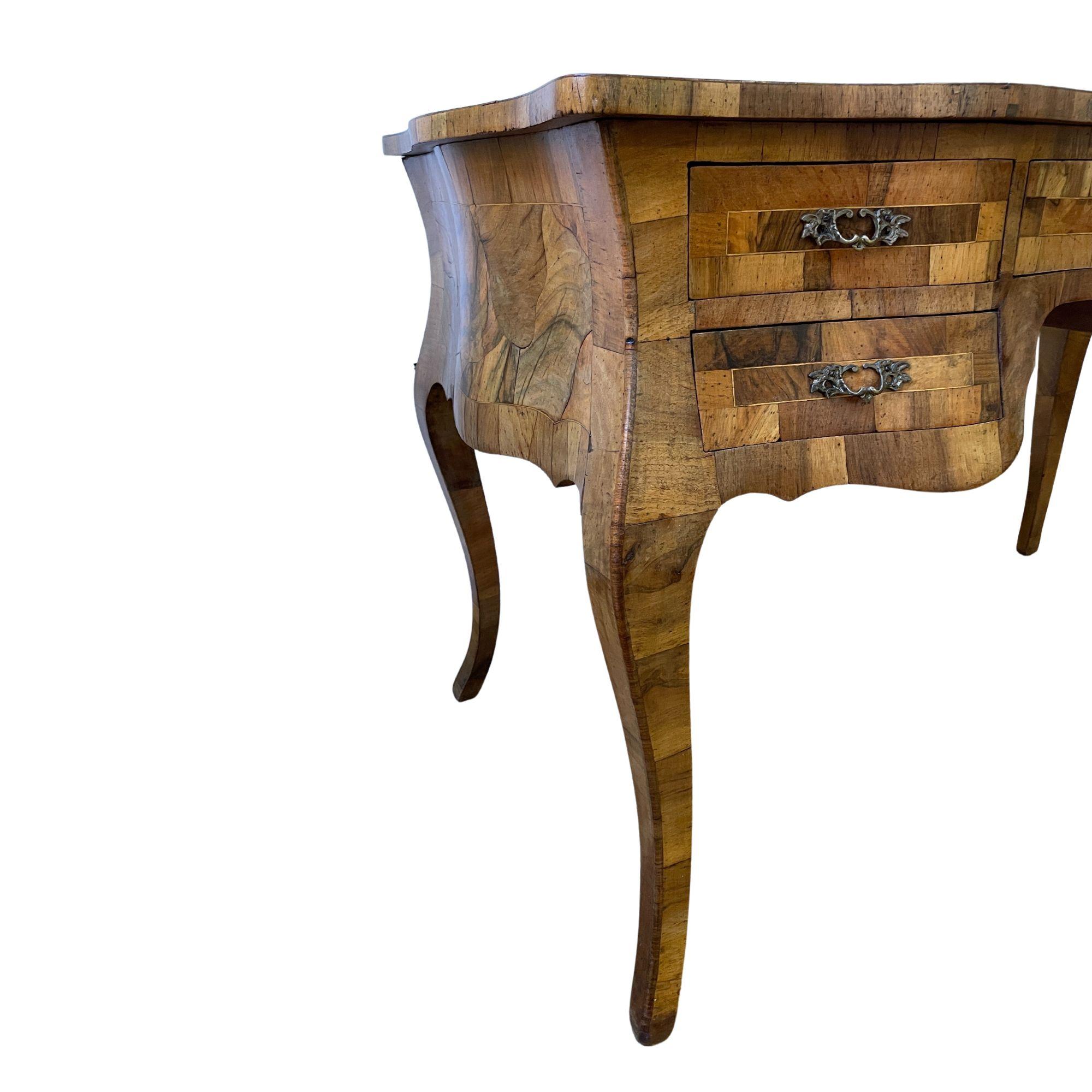 Hand-made Italian bombe burl bureau plat (writing desk) in the style of Louis XV. Patch olive and walnut burl with parquetry border on body of desk and each drawer. Curved forms are complimented by cabriole legs. Thought to be late 19th to mid-20th