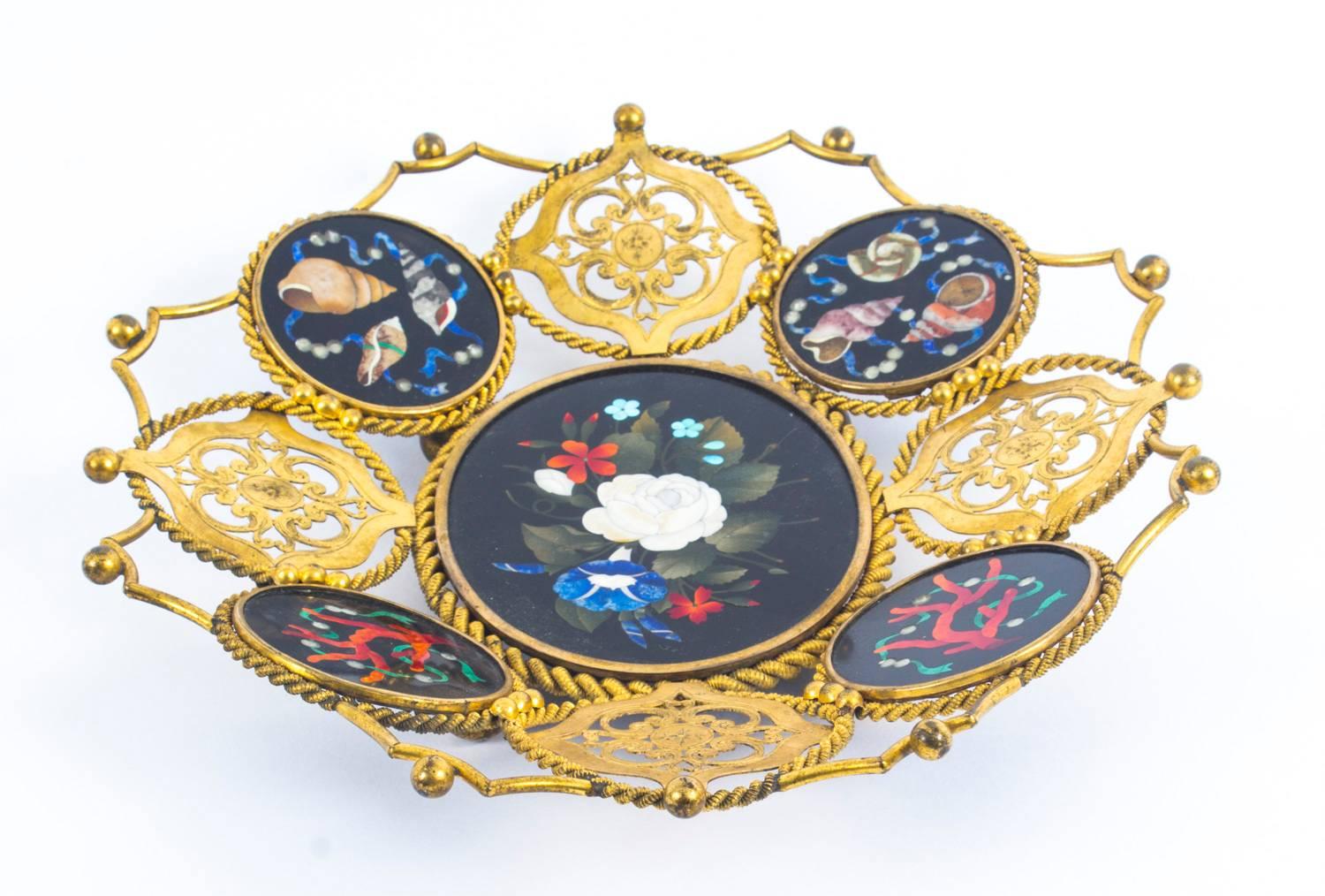 This is a superb quality antique Italian Pietra Dura mounted gilt bronze basket dating from the late 19th century.

Of striking pierced form set with four highly decorative Pietra Dura roundels depicting various corals and sea crustaceans, centred