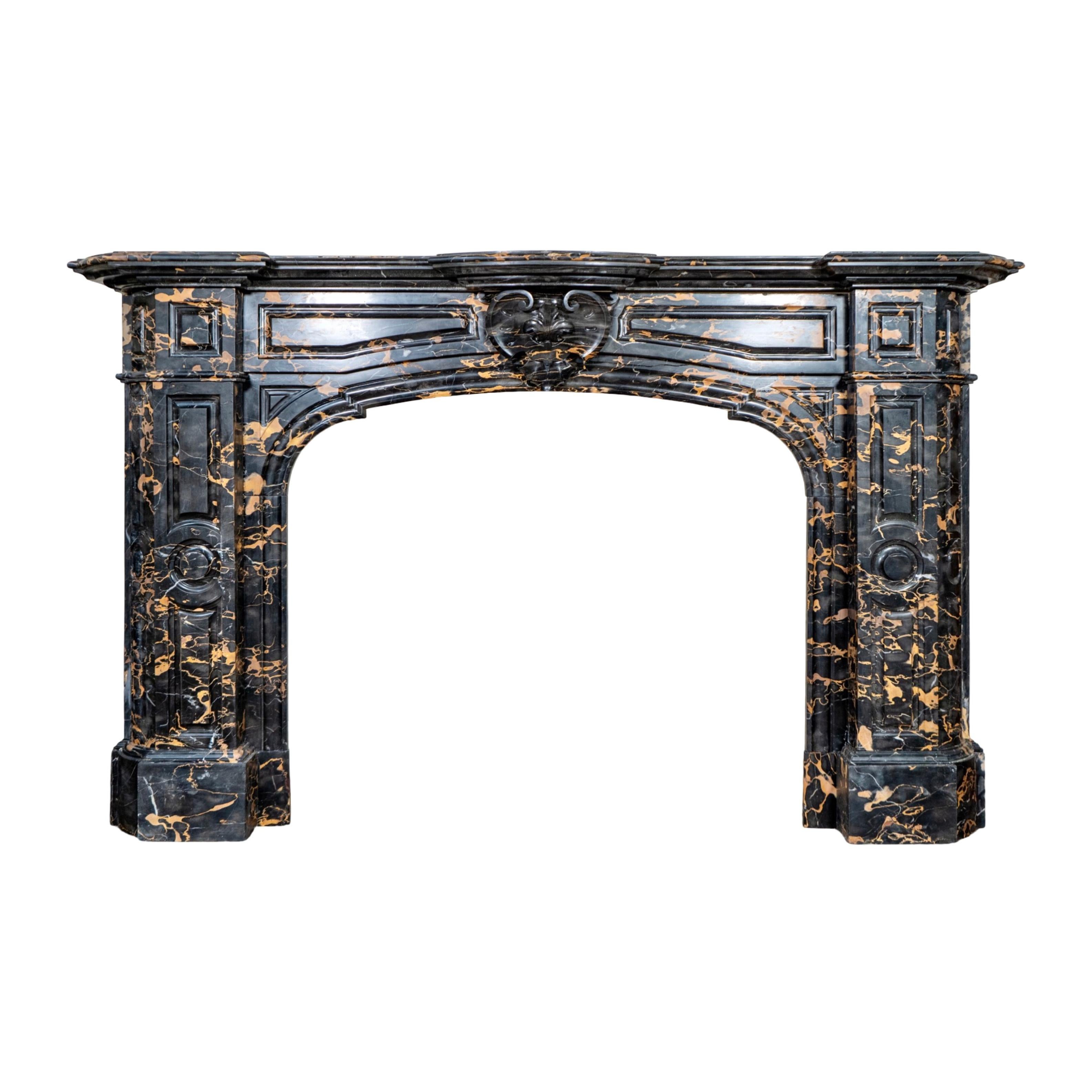  Carved in France during the 19th century, this antique and reclaimed mantel is made from Portoro marble, a rare Italian stone prized for its deep black ground laced with bold golden veining. The dramatic contrast of the stone alone makes this a