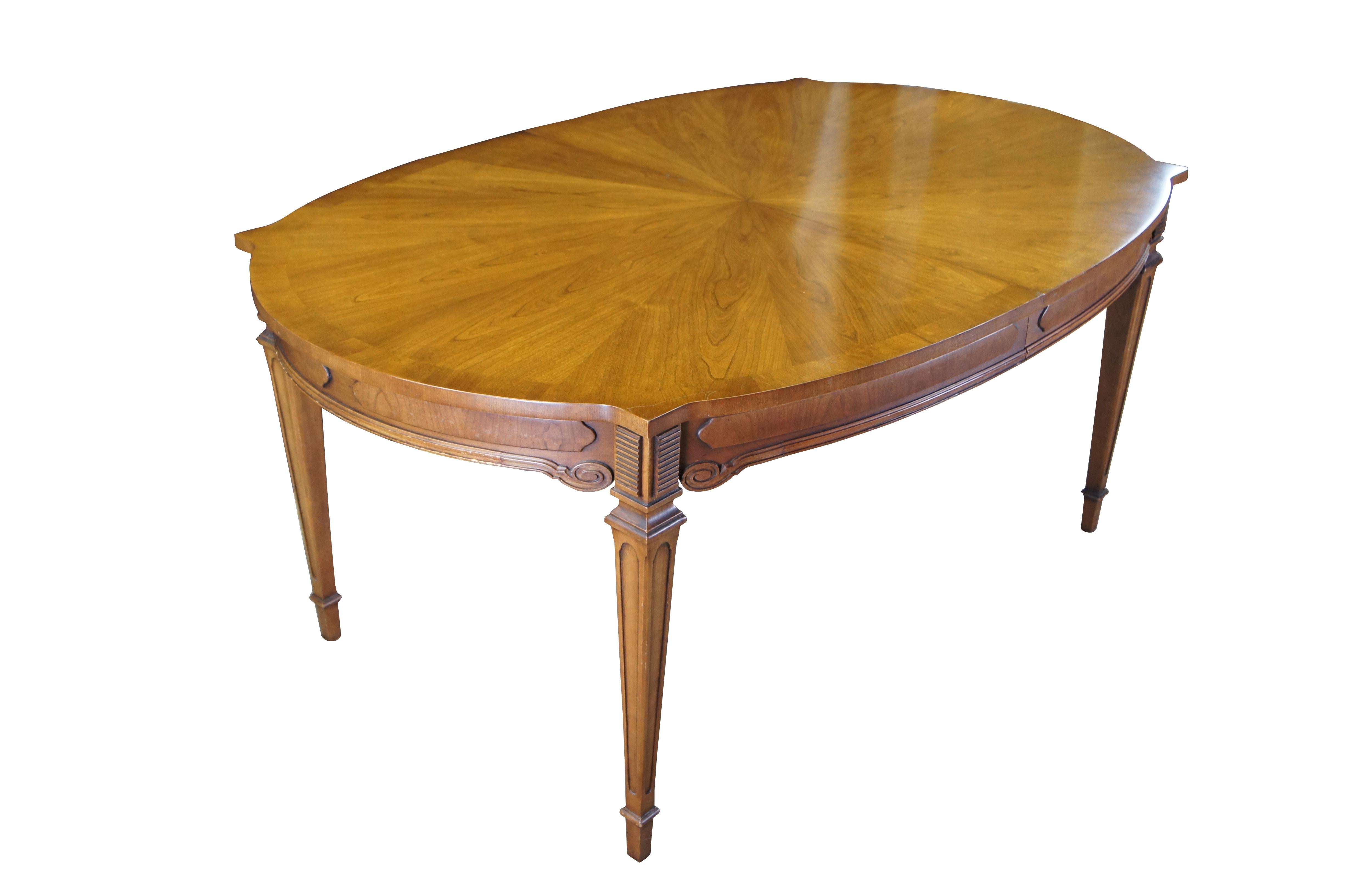 Antique Italian Provincial dining table.  Made of cherry featuring oval form with starburst style matchbook top, three leaves, and tapered legs.

Dimensions:
44