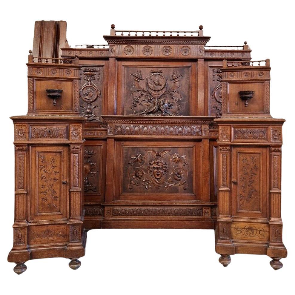 This Antique Italian Renaissance Revival Bed is a stunning example of the Renaissance style, with intricate carvings of Mythical creatures and Roman Gods in a rich brown waxed finish. Crafted from walnut in Italy in Circa 1850, this bed has a