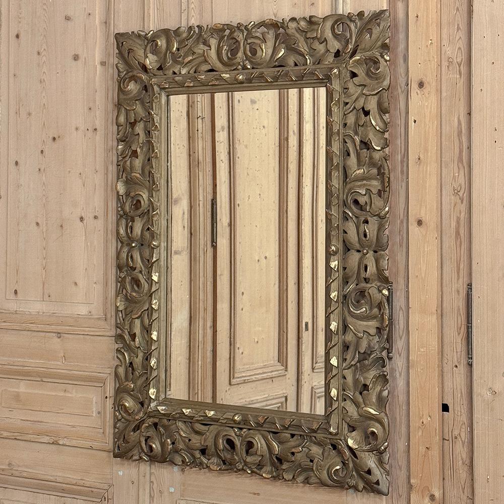 Antique Italian Renaissance Carved Giltwood Wall Mirror will make a timeless style statement in any room!  The generously sized frame is completely carved all around with acanthus foliate flourishes with corners styled after the classic fleur de