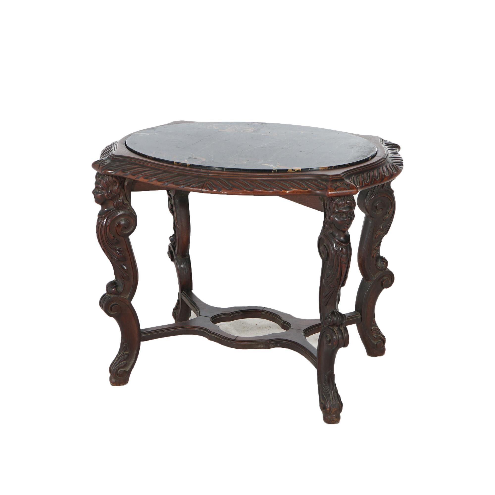 An antique Italian Renaissance figural side table offers picture frame inset black specimen marble top over walnut base having legs with carved caryatids and scroll legs, c1910

Measures - 20.5