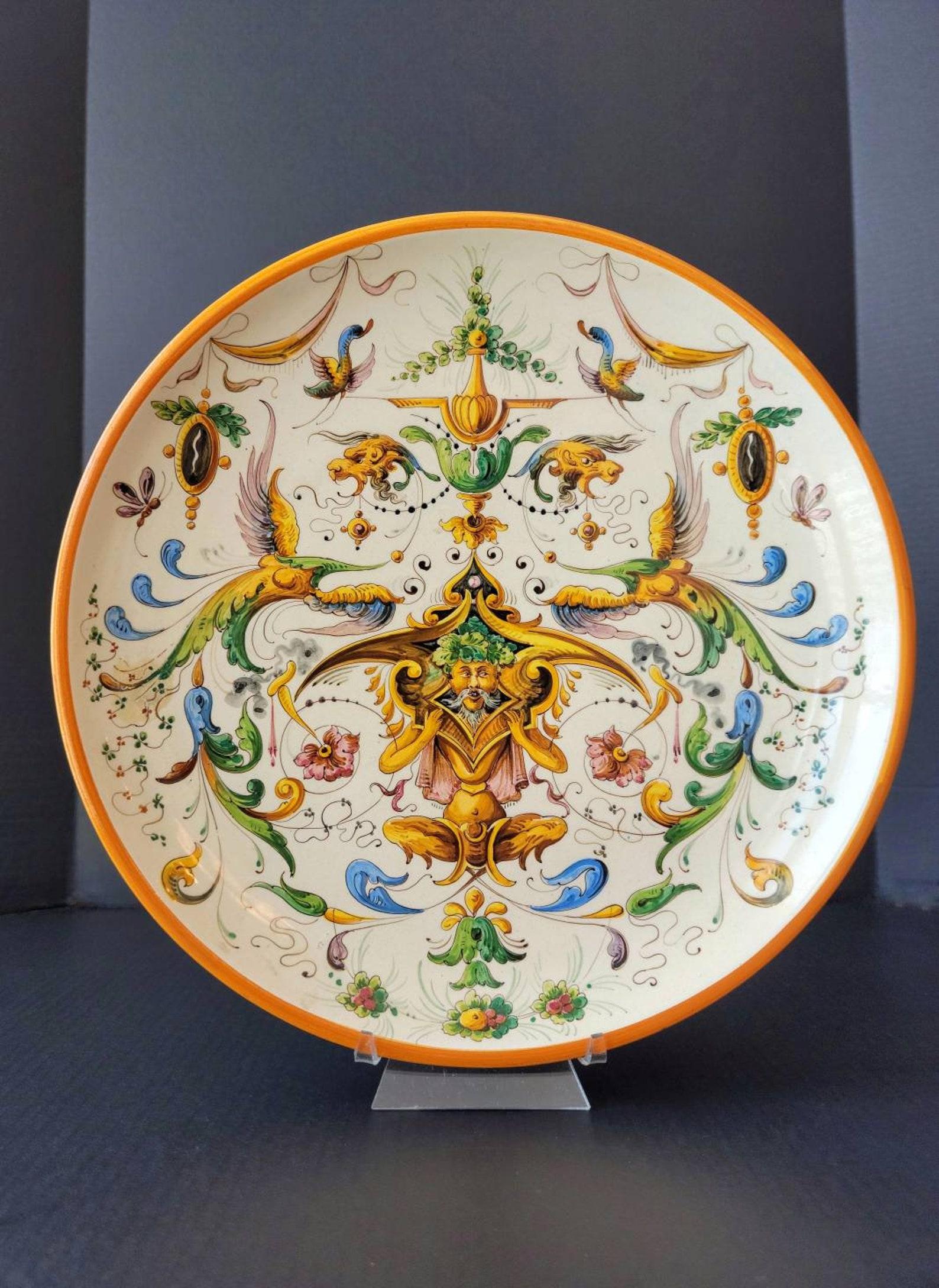 A stunning large antique Italian Raffaellesco majolica wall charger / centerpiece, showcasing exceptionally executed handmade and painted design, dating to the 19th century or earlier.

Shallow bowl-form plate - platter raised on circular foot,