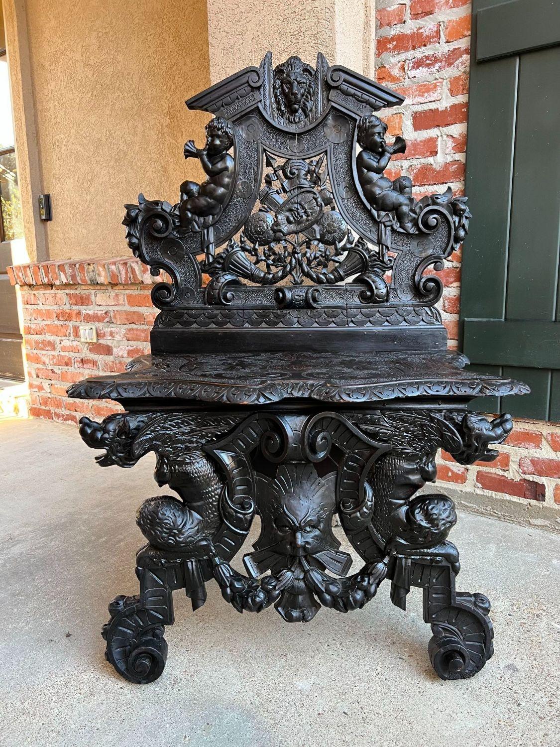 Antique Italian Renaissance Revival Hall Bench Throne Ebonized Carved Oak Cherub.

Direct from Italy, a fabulous 19th century Italian hall seat, bench, settee or throne chair!! Spectacular design with beautiful hand carvings throughout. Large lion