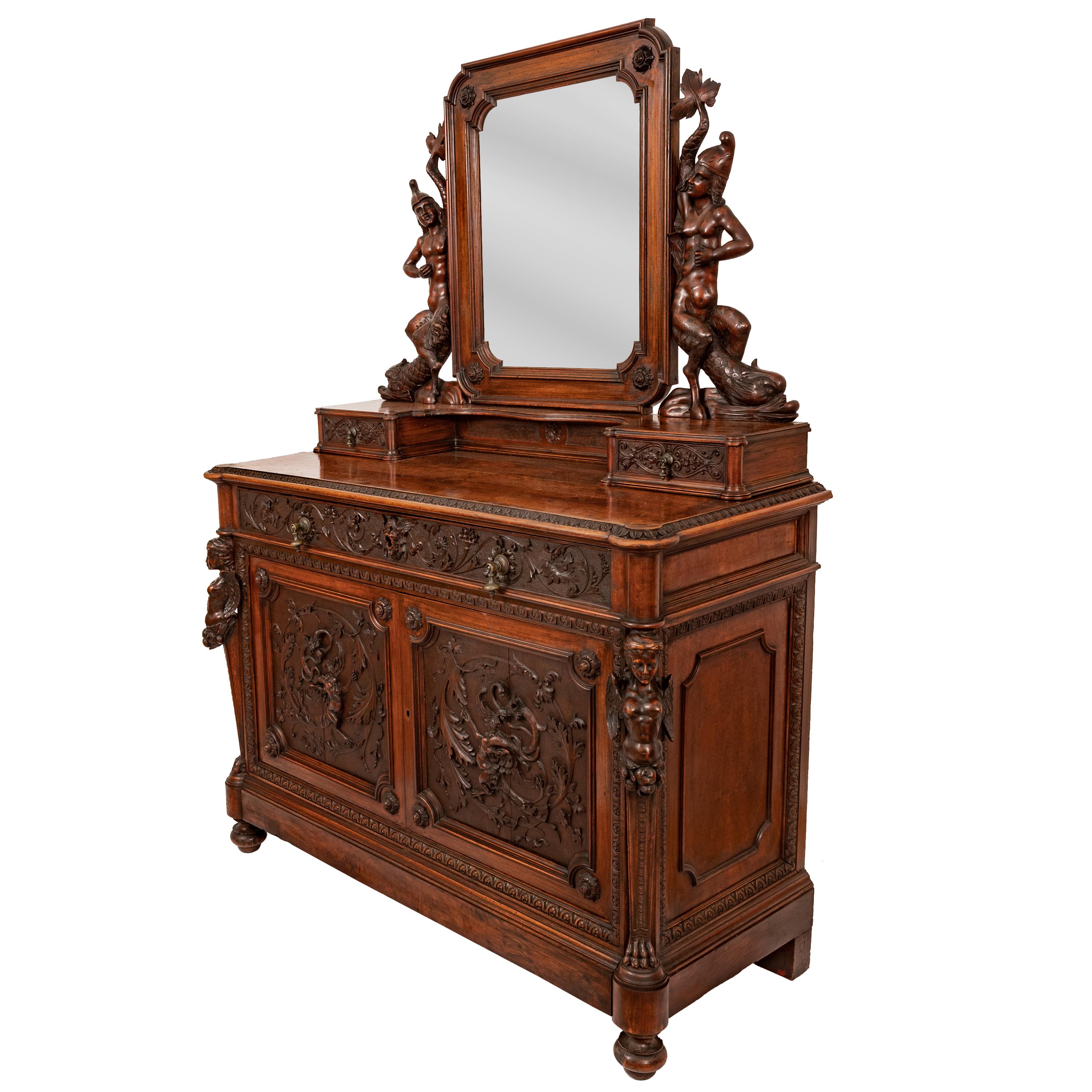 A superbly carved antique Italian Renaissance Revival mirror back dressing chest, circa 1870.
The dresser extols the art of the Italian carver at his very finest, the adjustable mirror back supported with two carved mermaids with horses hooves and