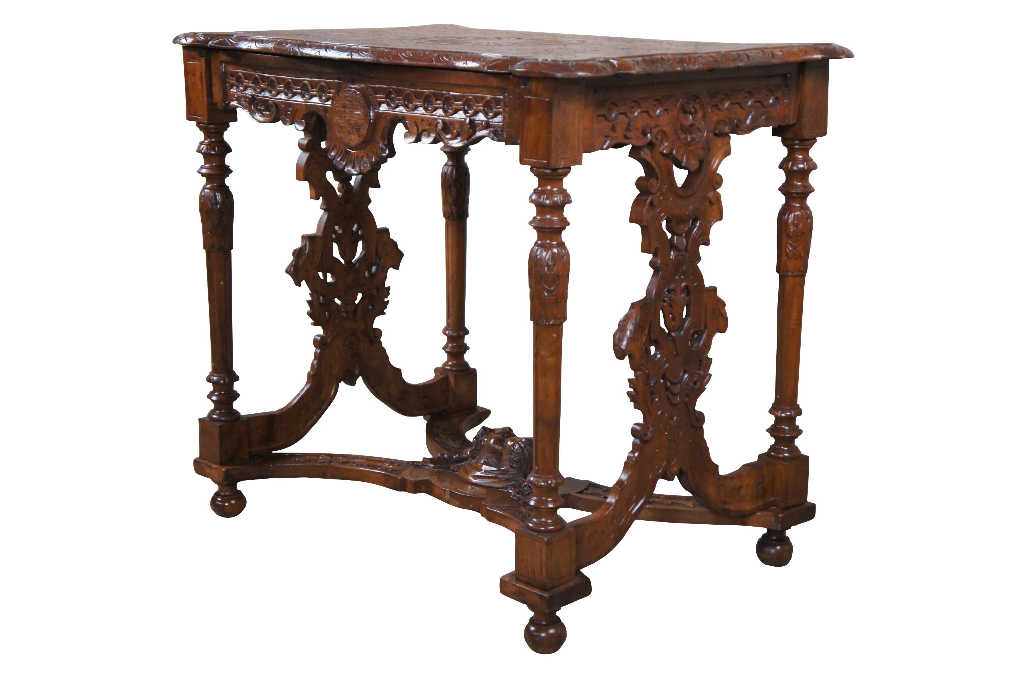 Antique Neo-Renaissance Revival parlor / library table or writing desk, circa 1870s Made of walnut featuring Neoclassical styling with high relief figural carvings of cherubs / puttis and acanthus / floral designs. The table has a carved top with