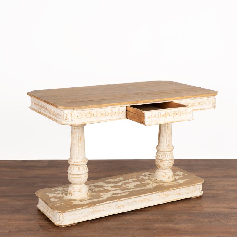 Beautiful lines define this striking Italian Renaissance style console table. Crafted in pine, the white painted finish has been scraped and distressed to reveal the pinewood below, adding character and depth to the finish while highlighting carved