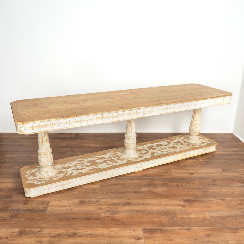 Beautiful lines define this striking 8’ long Italian Renaissance style console table. Crafted in pine, the white painted finish has been scraped and distressed to reveal the pinewood below, adding character and depth to the finish while highlighting