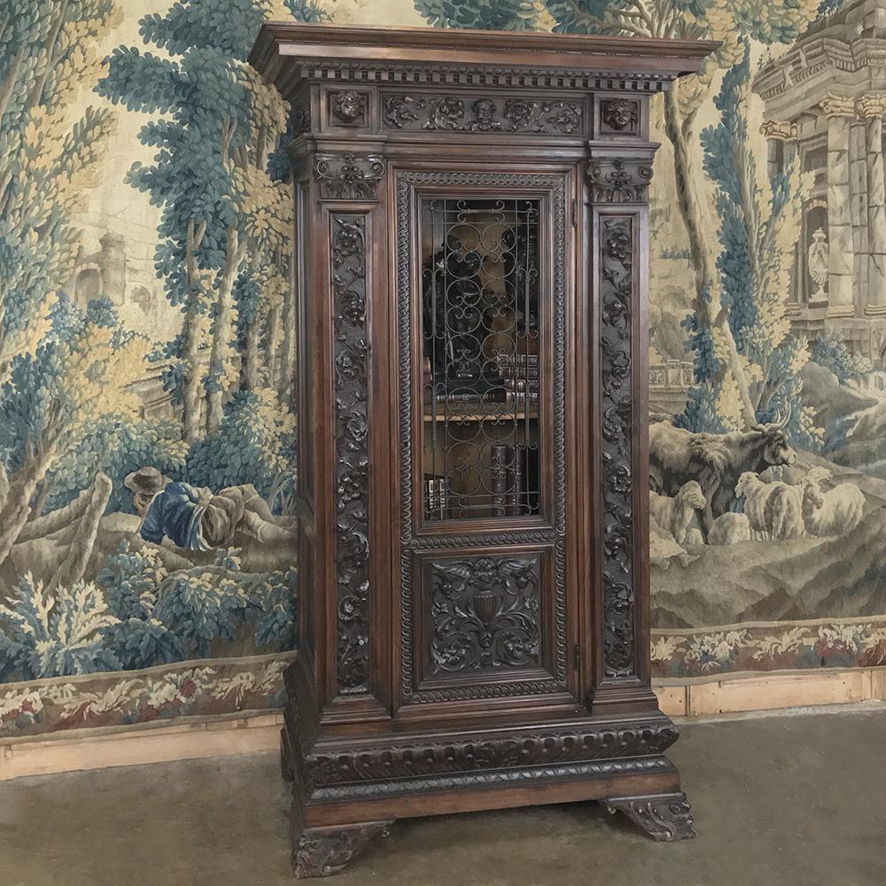 Antique Italian Renaissance walnut curio cabinet is the perfect vertically oriented display case for your cherished family heirlooms or prized collection! Also useful as a wine storage cabinet, it has been hand carved with elaborate relief work