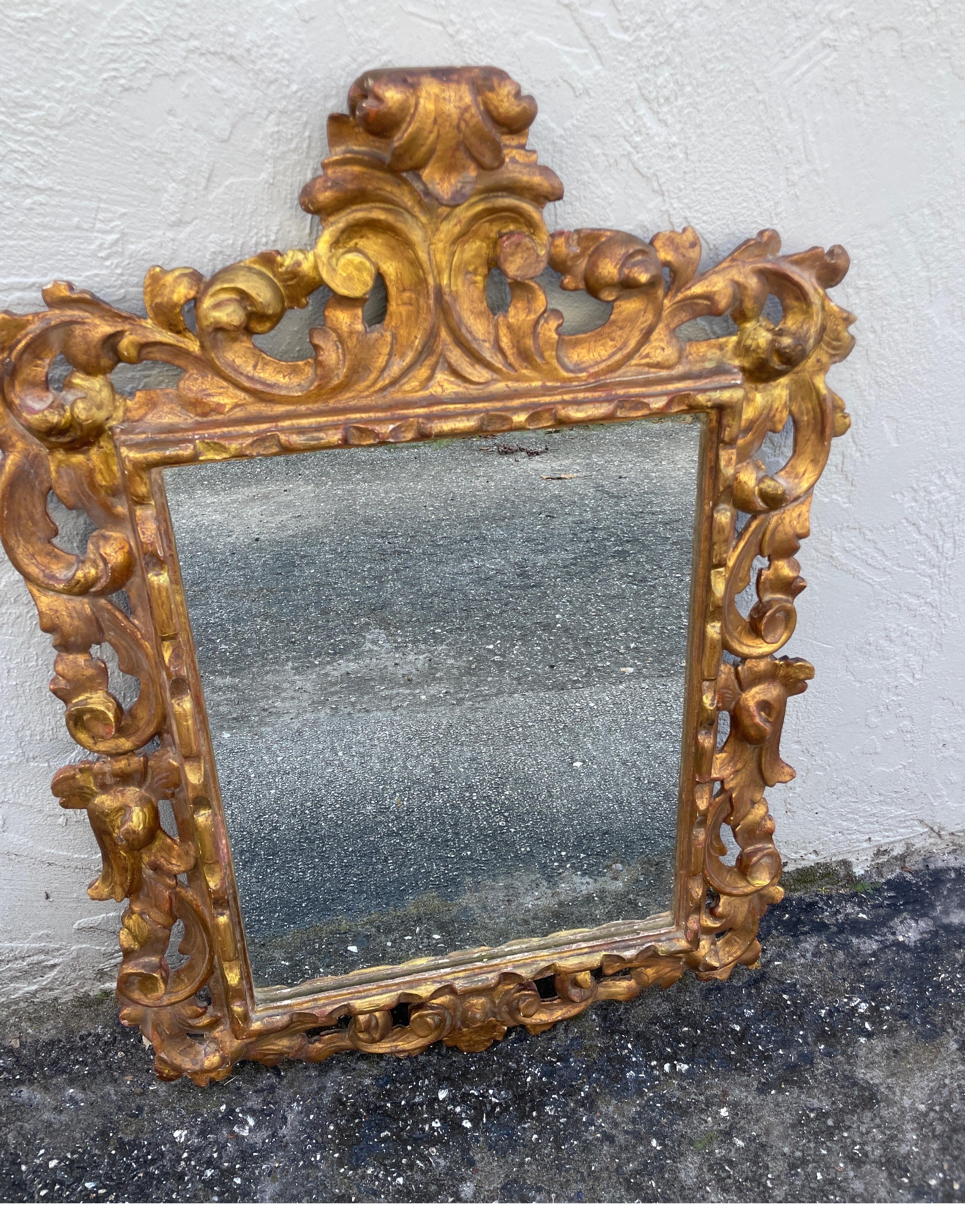 Antique Italian hand carved and gilded Rococo style wall mirror.