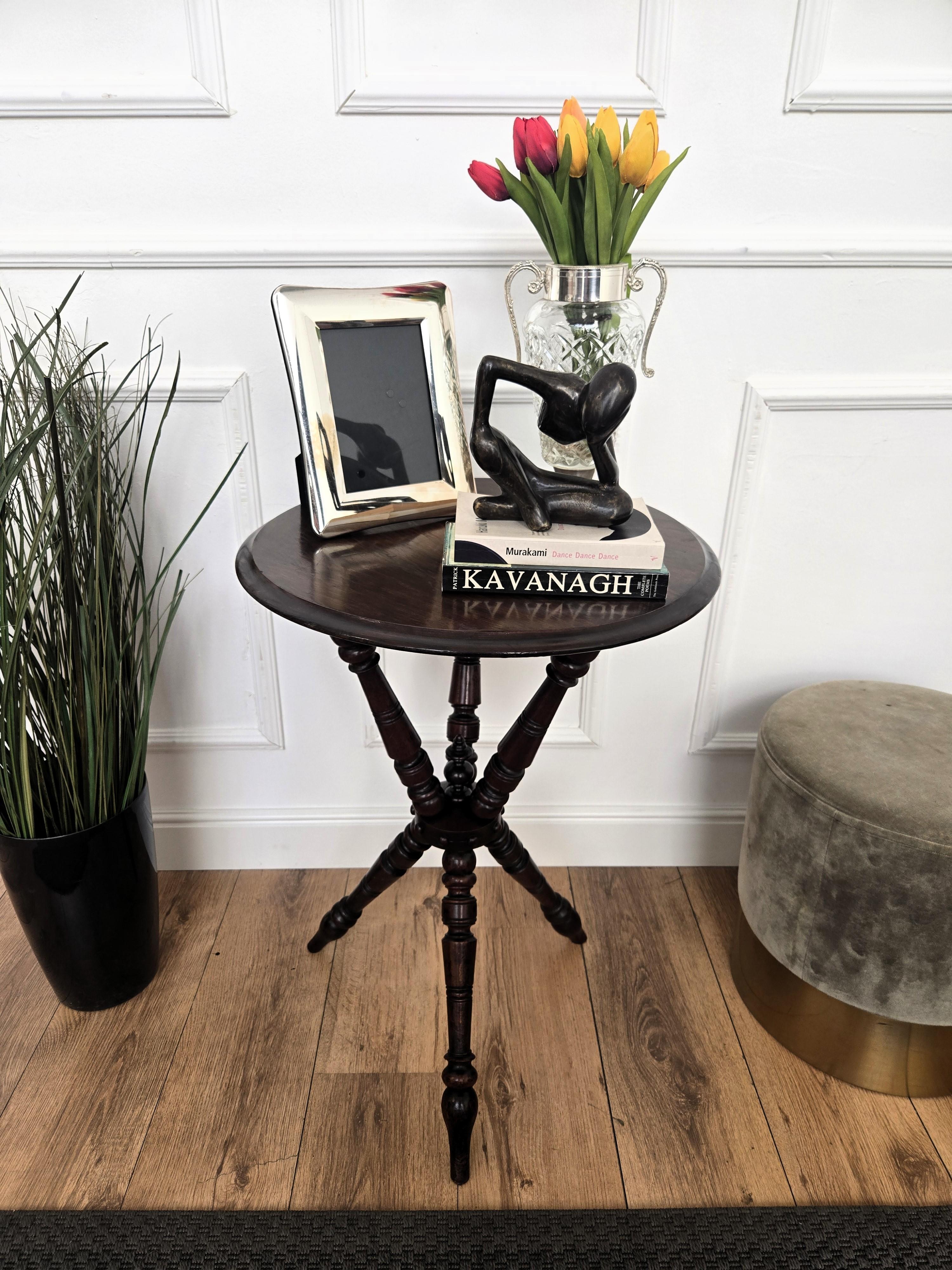 Beautiful antique wooden Italian walnut side table or occasional table with beveled round top raised on three beautifully turned legs connected by a great bun shaped stretcher. This Italian walnut side table with the rich and beautiful patina would