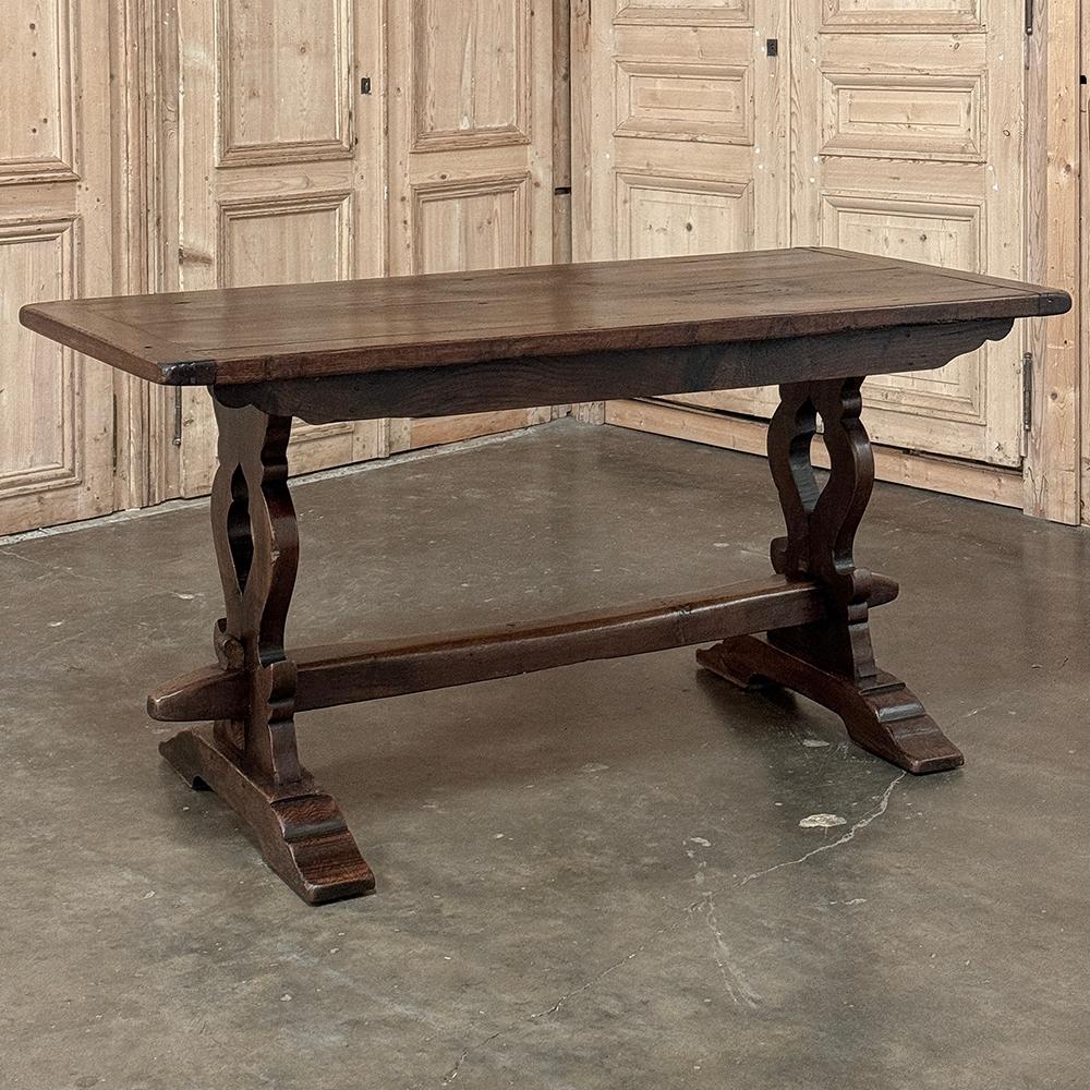Antique Italian Rustic Style Trestle Table was crafted by talented Belgian furniture makers, influenced by Italian masters of a bygone era.  Utilizing thick, solid planks of old-growth oak, the sturdy top was fashioned then supported by urn-form leg