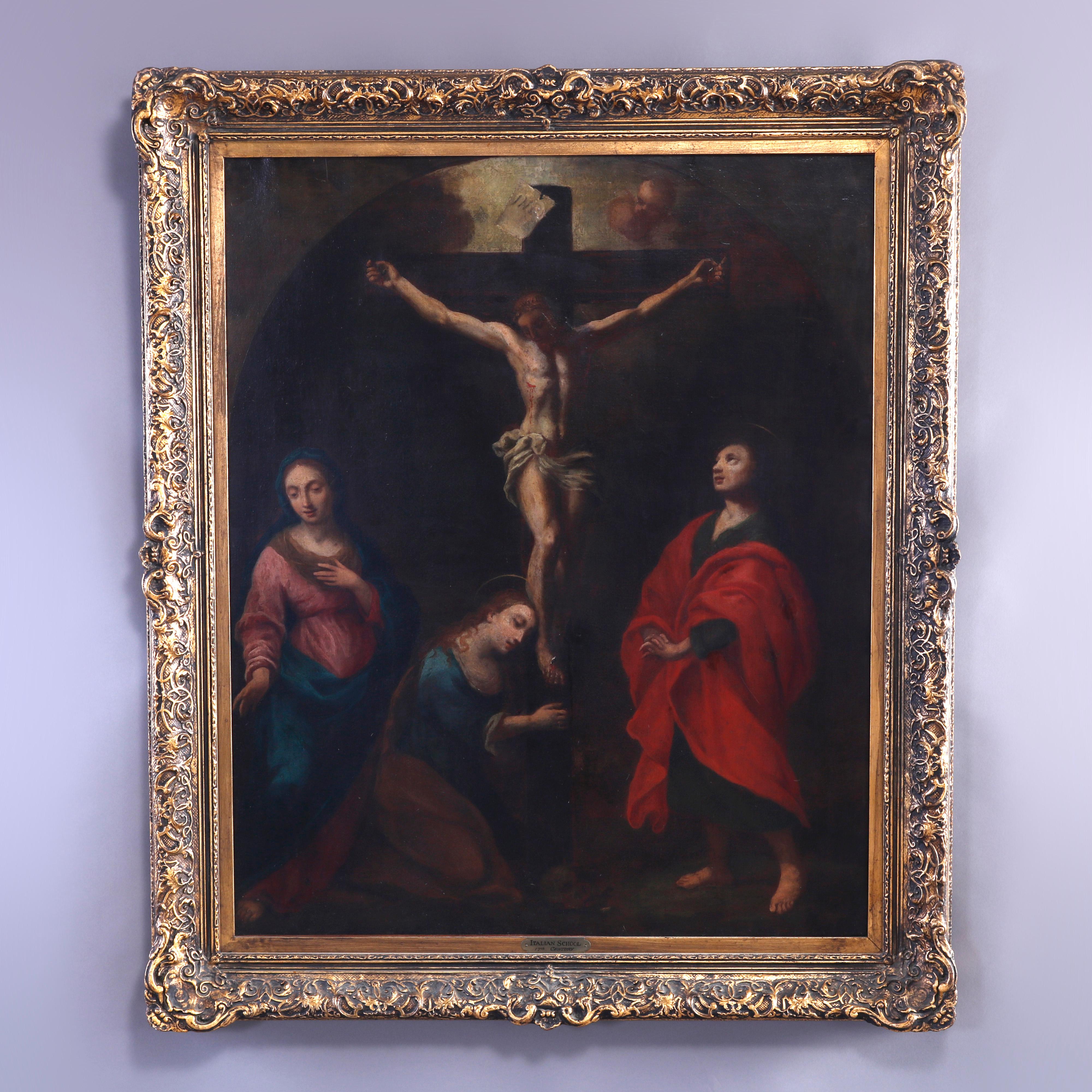 An antique Italian School painting offers oil on canvas depiction of the Crucifixion of Jesus Christ, seated in giltwood frame, 19th century

Measures - overall 41.25''H x 35''W x 3''D.