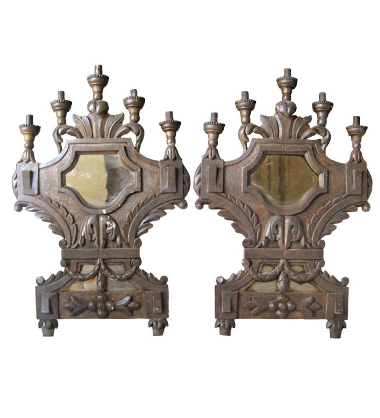18th century Tuscan wooden pair of 5-light mirrored sconces. Rare pair of Tuscan antique Italian sconces that are large in scale with detailed carving. Narrow depth make these terrific in a hallway or flush mounted setting. Antique mirror has