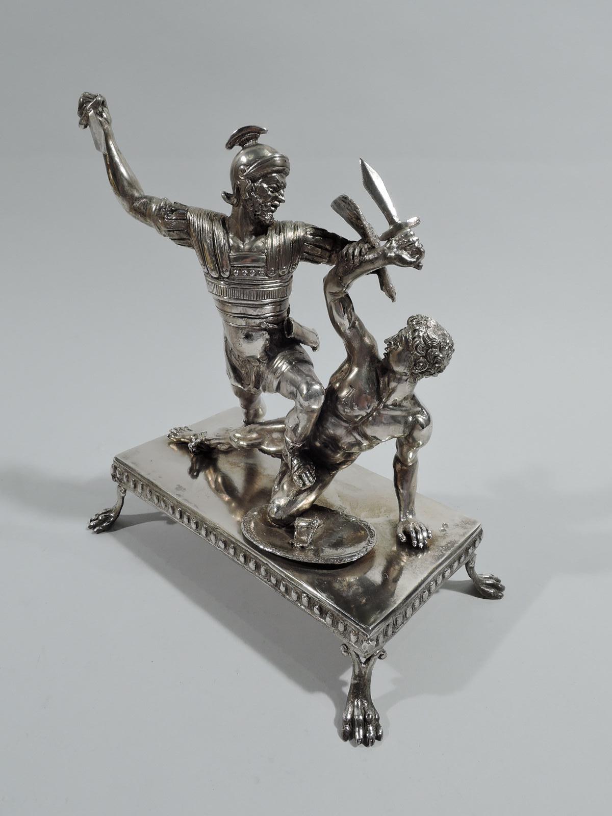 Italian grand tour cast silver sculpture, ca 1910. Roman gladiators clash with swords drawn. The apparent victor, helmeted and armored, stands with sandaled foot on his victim’s thigh. The fallen man’s retaliatory thrust is blocked by a