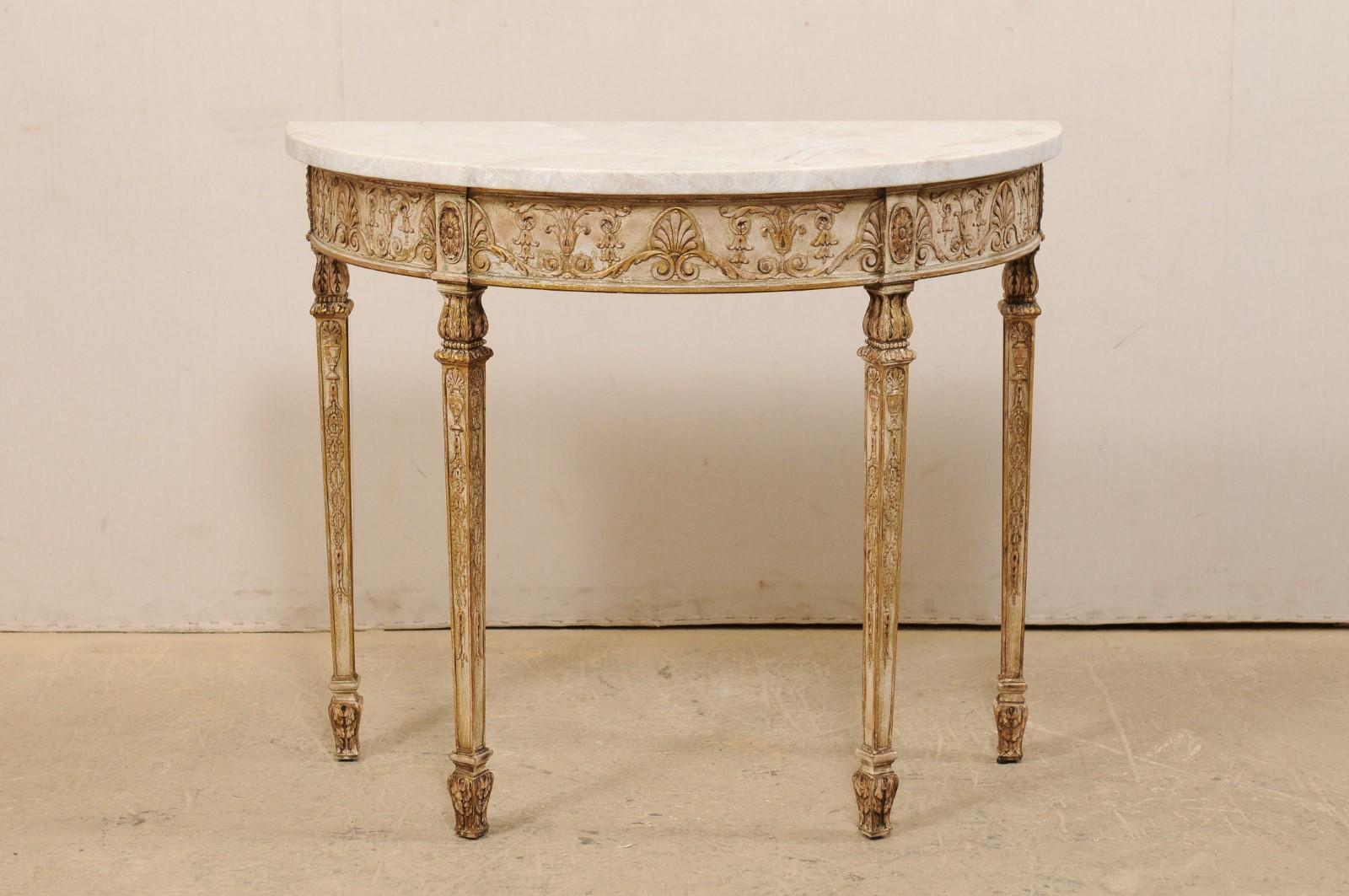 An Italian-style console demilune table from the early 20th century, with a new marble top. This antique table from furniture maker Wm Baumgarter & Co, was designed with Italian aesthetic, featuring a half-moon top with an exquisite carved apron