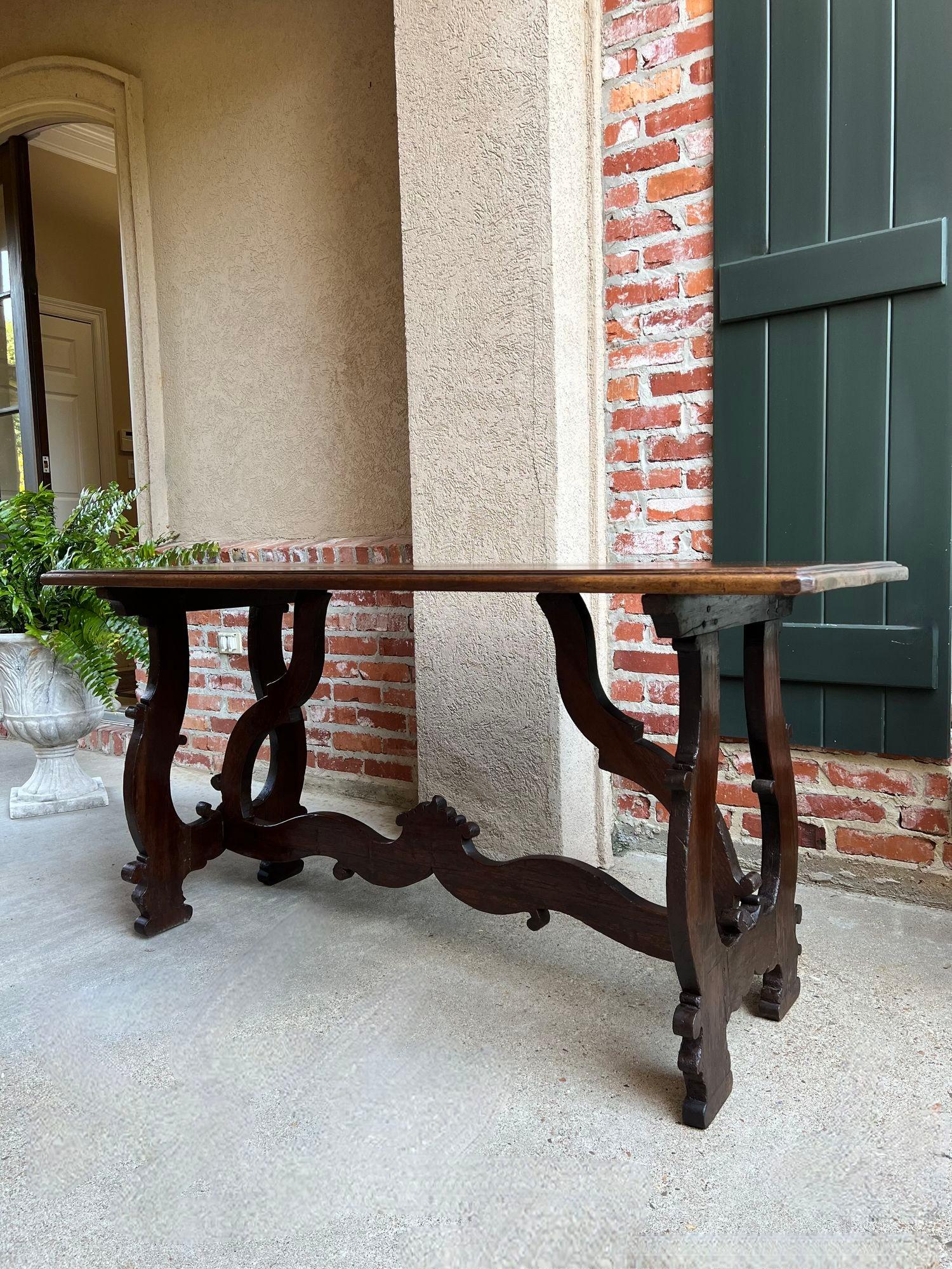 Antique Italian Trestle Dining Table Desk Walnut 6 ft Console Table circa1800.

Direct from Italy, a fabulous antique walnut dining table (or console/conference/library desk). Stunning hand carved construction, with wide shaped legs, trestle, and