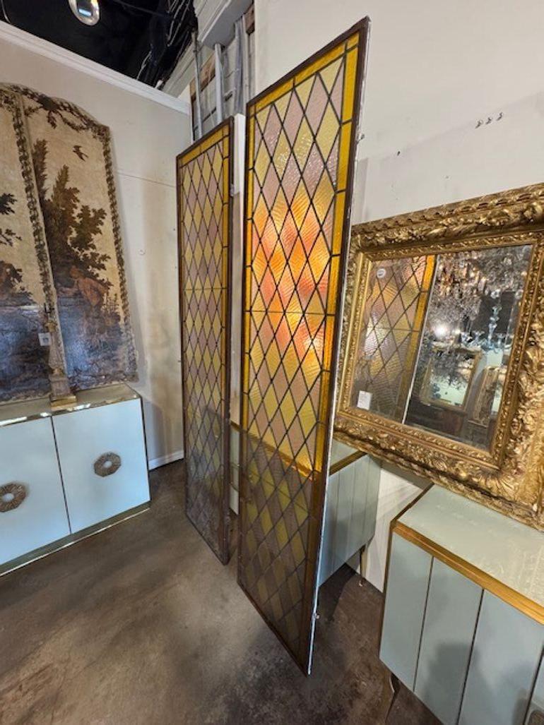 These antique Italian tri-color stained glass windows are a beautiful and unique addition to any home or building. The geometric designs and muted colors add a touch of elegance to any space, making them a sought-after piece for those looking to add