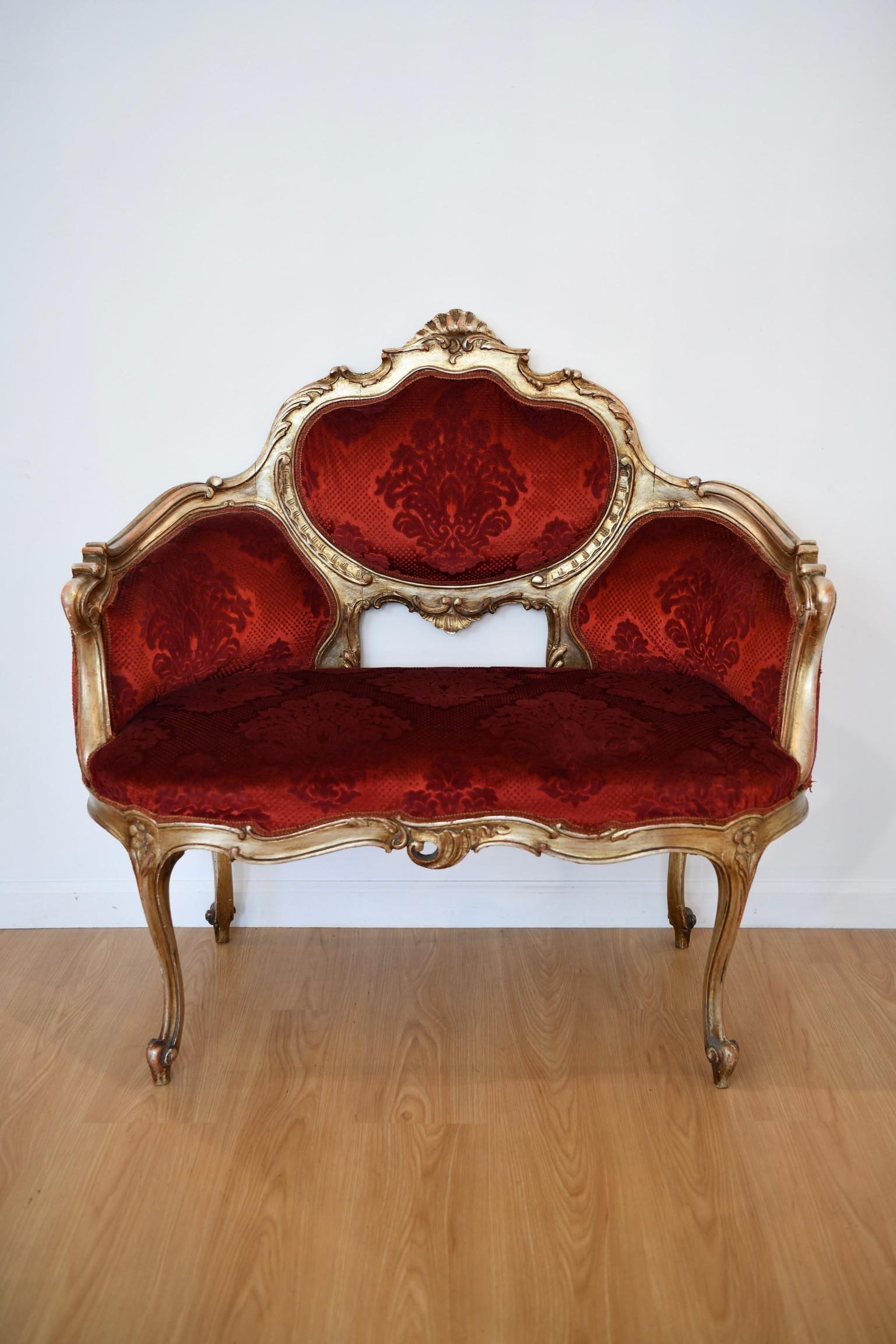 Antique Italian crimson velvet upholstered settee with gilt frame. Some fraying to upholstery trim; otherwise in good vintage condition. Dimensions: 42