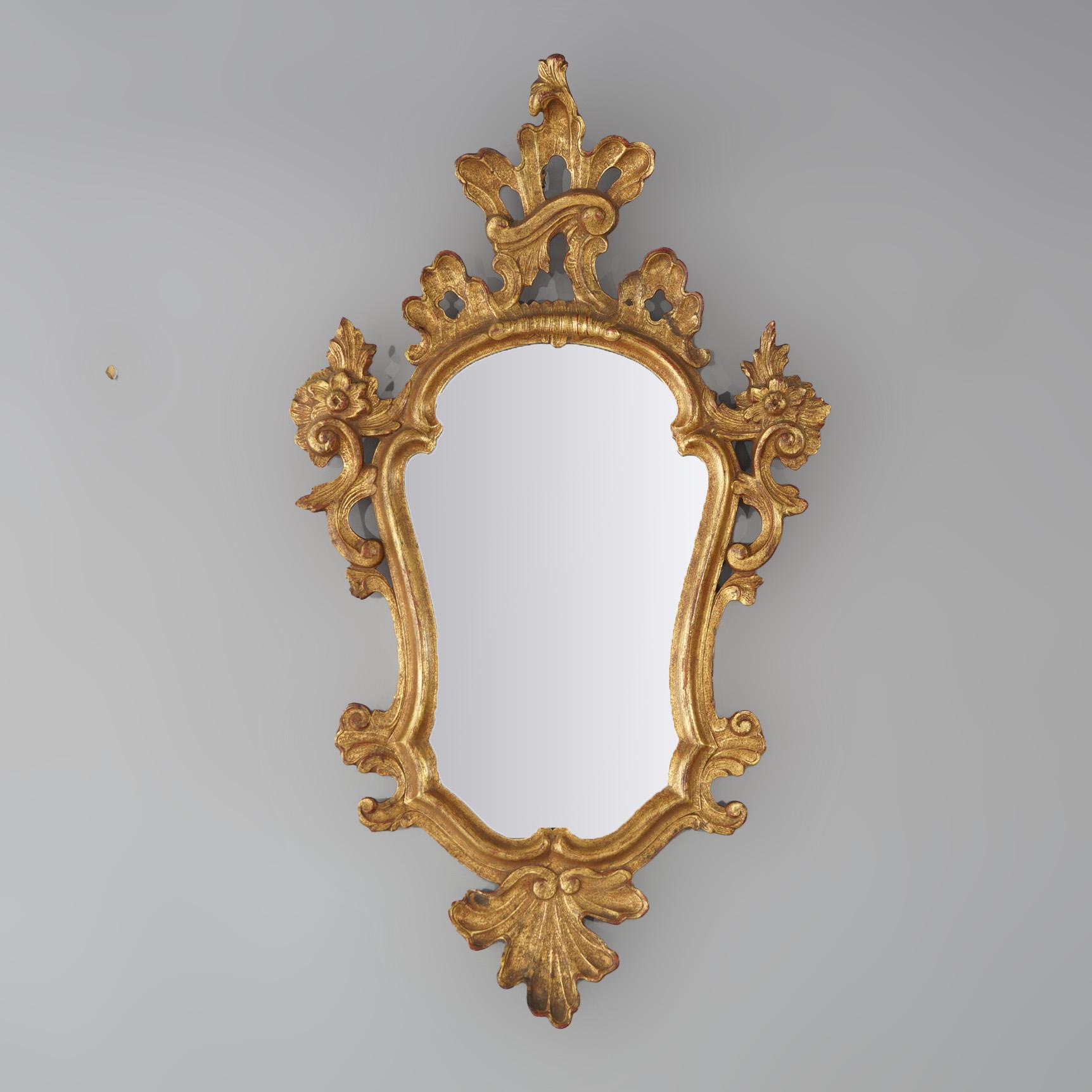 An antique Italian Venetian wall mirror offers shaped giltwood frame in foliate and floral form, c1920

Measures- 35''H x 19.75''W x 2.25''D; 18.5'' x 11.75'' sight
