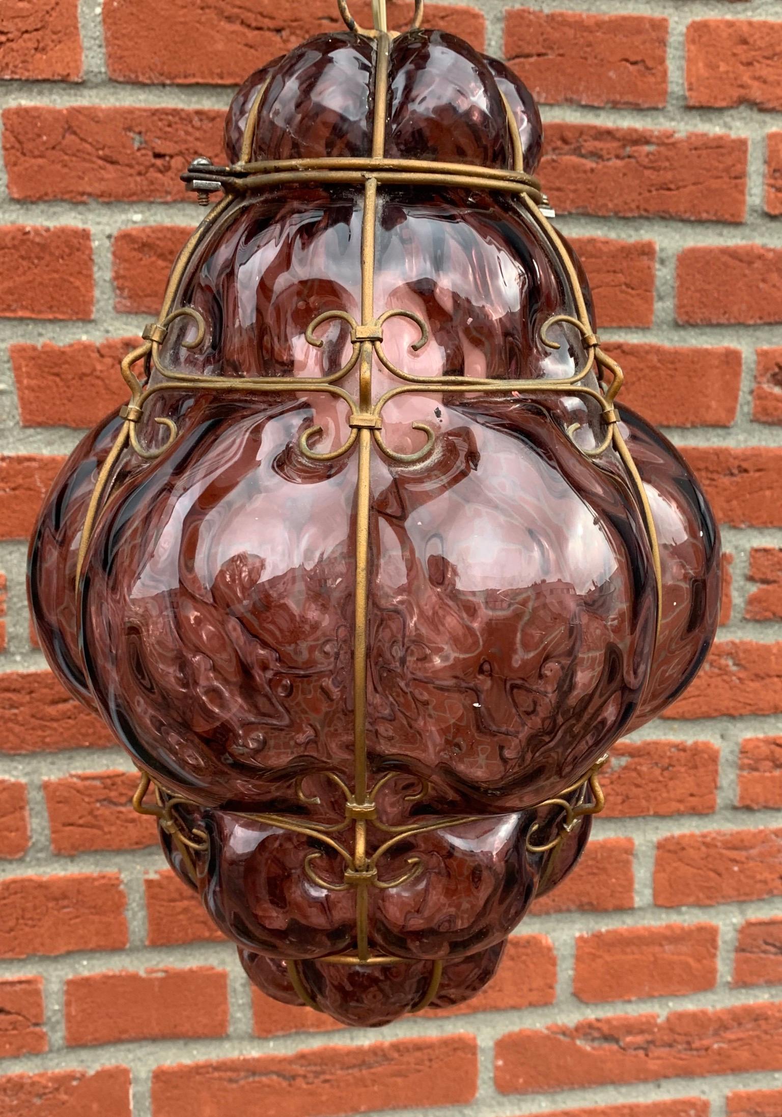 Beautiful color and practical size fixture with mouthblown glass in a metal frame.

If you are looking for a rare and stylish fixture to grace your home then this handmade antique specimen could be perfect. With early 20th century lighting as one of