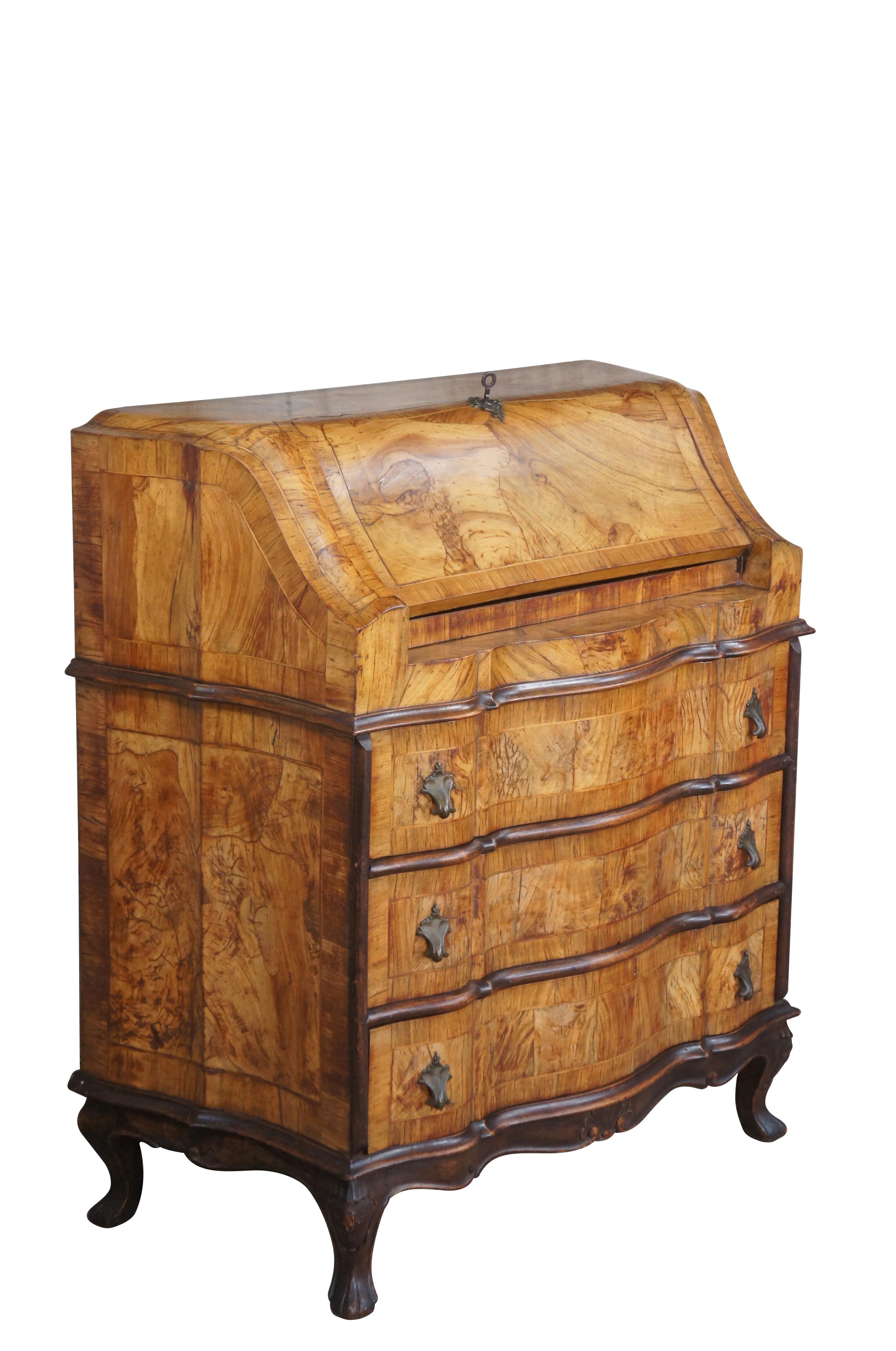 An impressive antique Italian Venetian drop front secretary desk.  Made from olive burl with a downswept lid and serpentine frame. Each panel shows off exquisite burl and shapely cross banding.  The unique writing surface opens to 4 drawers and a
