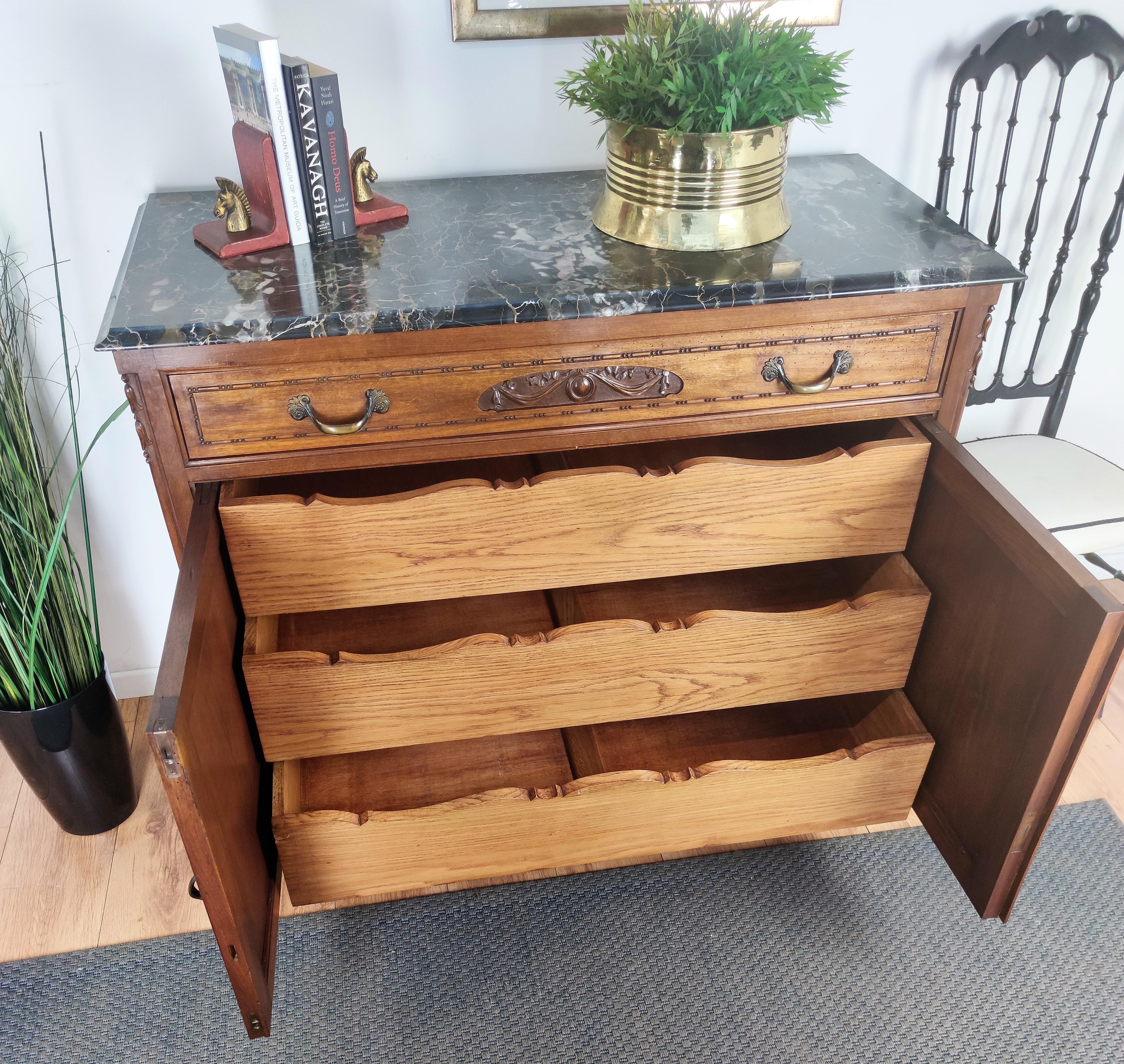 Very elegant Italian chest of drawers, with 3 greatly carved drawers hidden behind the two doors. This commode cabinet is in beautiful carved walnut wood, with floral classic decors on the top drawer and the two doors, refined by great details such