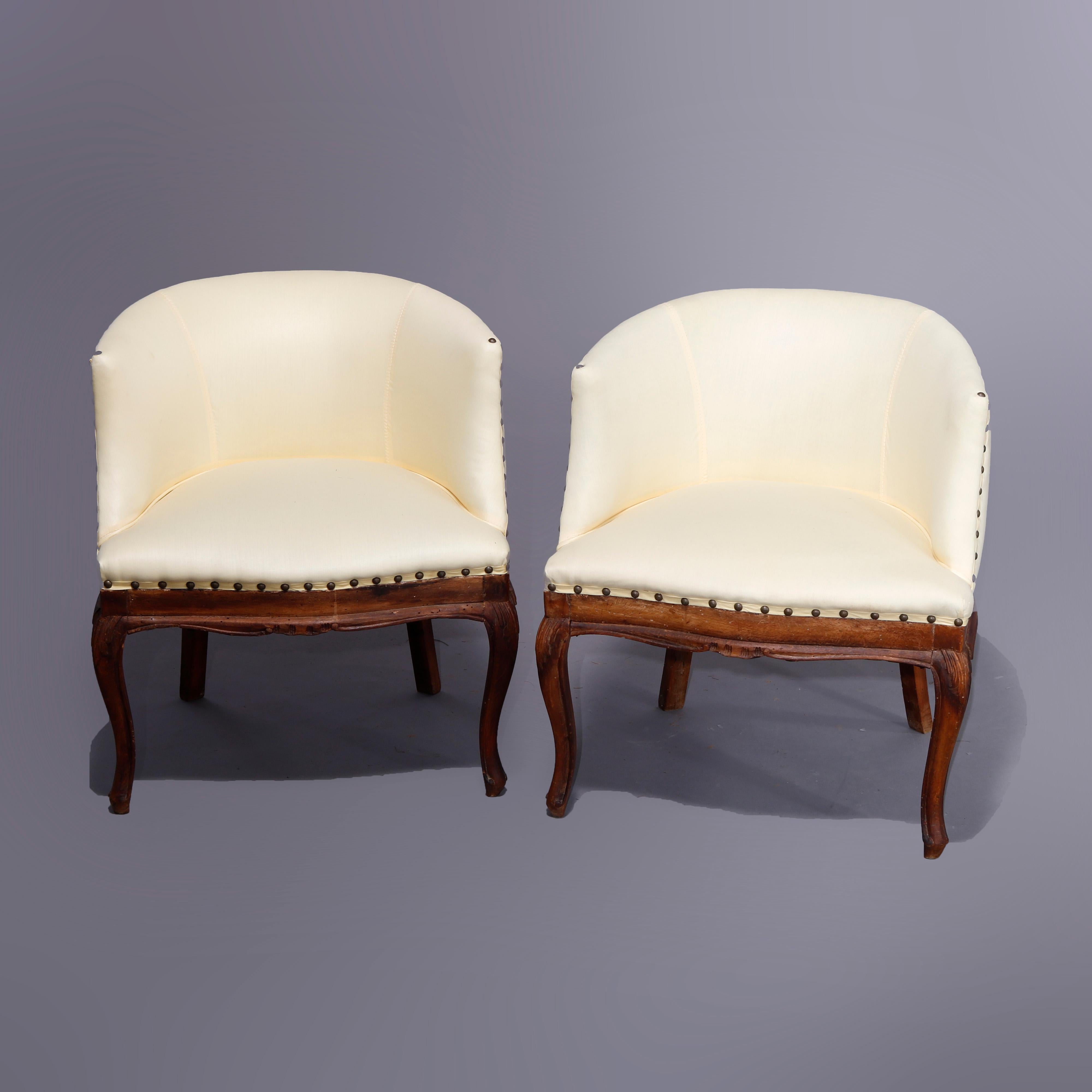 An antique pair of Italian side or lounge armchairs offer curved upholstered backs over walnut bases having cabriole legs with carved acanthus knees, newly reupholstered, late 18th to early 19th century.

Measures - 25.5''H x 23.5''W x 21.5''D.
 
