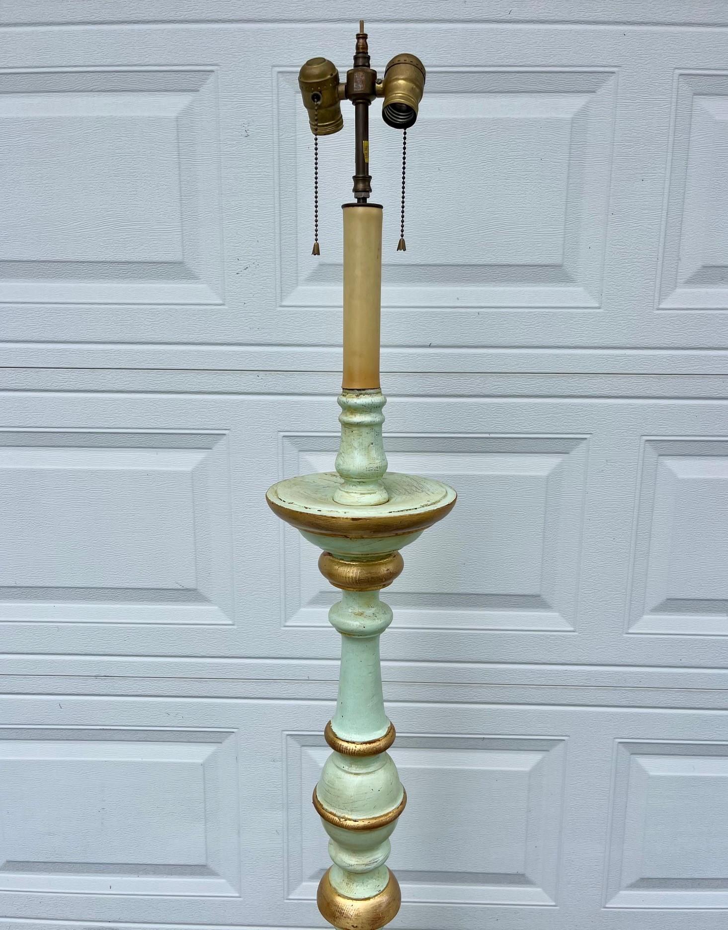 Antique Italian Wood Carved Baroque Style Torchiere Two Light Floor Lamp.

Early 20th century hand carved and turned Baroque style two light electrified torchiere. The turned body is polychrome painted in Venetian green with gilt parts. This floor