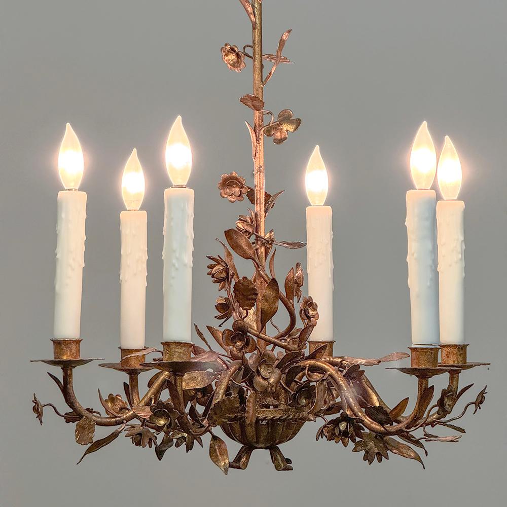 Antique Italian Wrought Iron Gilded Chandelier is a lovely way to decorate your room and provide illumination that only antique lighting can provide!  Designed to celebrate the Belle Epoque movement, it features gracefully scrolled arms affixed to a