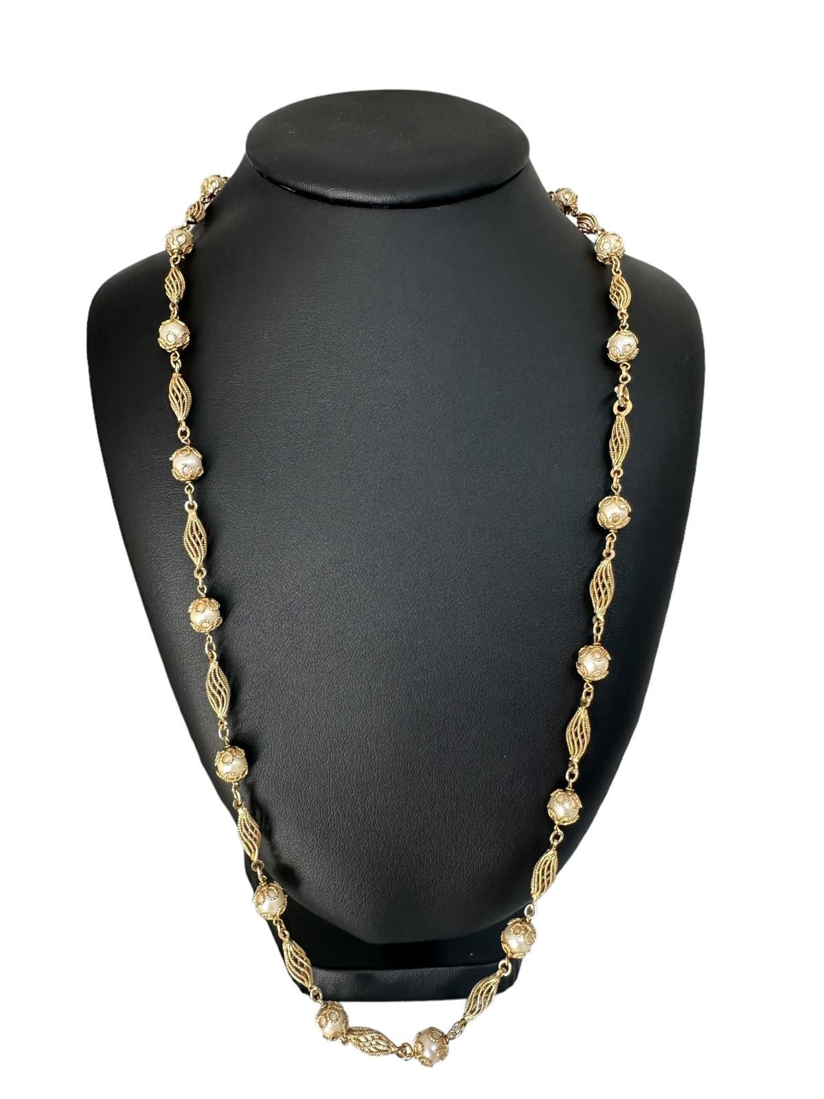 This Antique Italian Yellow Gold and Natural White Pearls Necklace is a stunning piece that exudes elegance and timeless beauty. Crafted from luxurious 18 karat yellow gold, this Victorian-style necklace showcases exquisite craftsmanship and classic