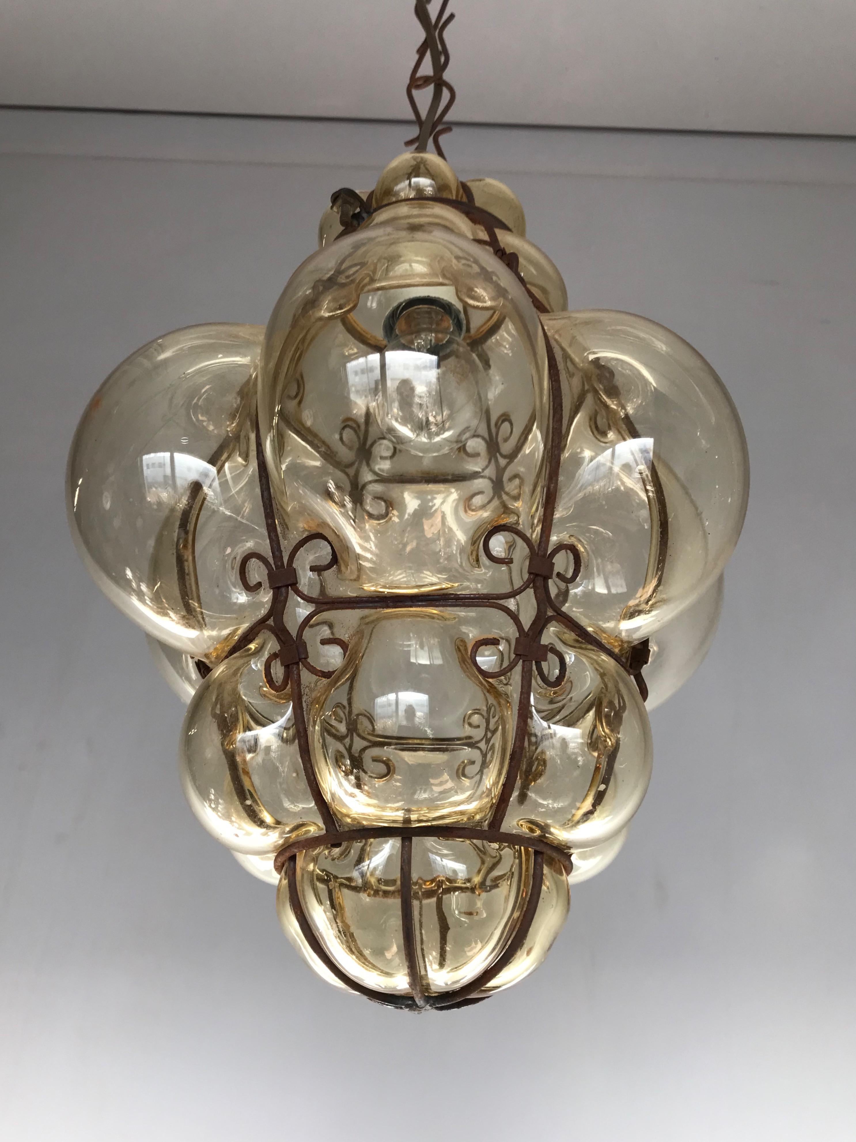 Beautiful color and practical size fixture with mouthblown glass in a metal frame.

If you are looking for a rare and stylish fixture to grace your home then this handmade antique specimen could be perfect. With early 20th century lighting as one