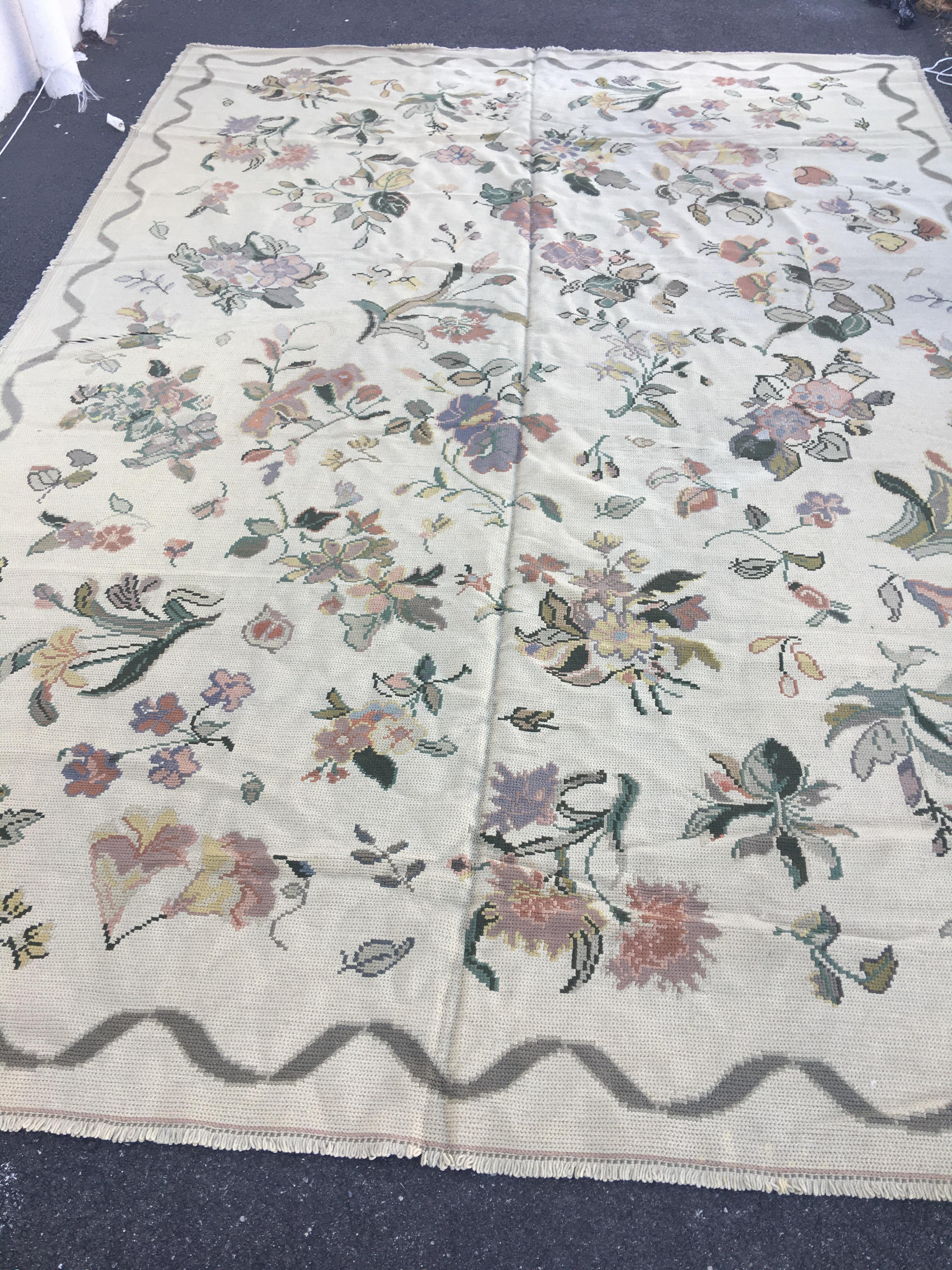 Antique Ivory Portuguese needlepoint with flowers, circa 1930-1940s. It measures: 8 x 11.8 ft.