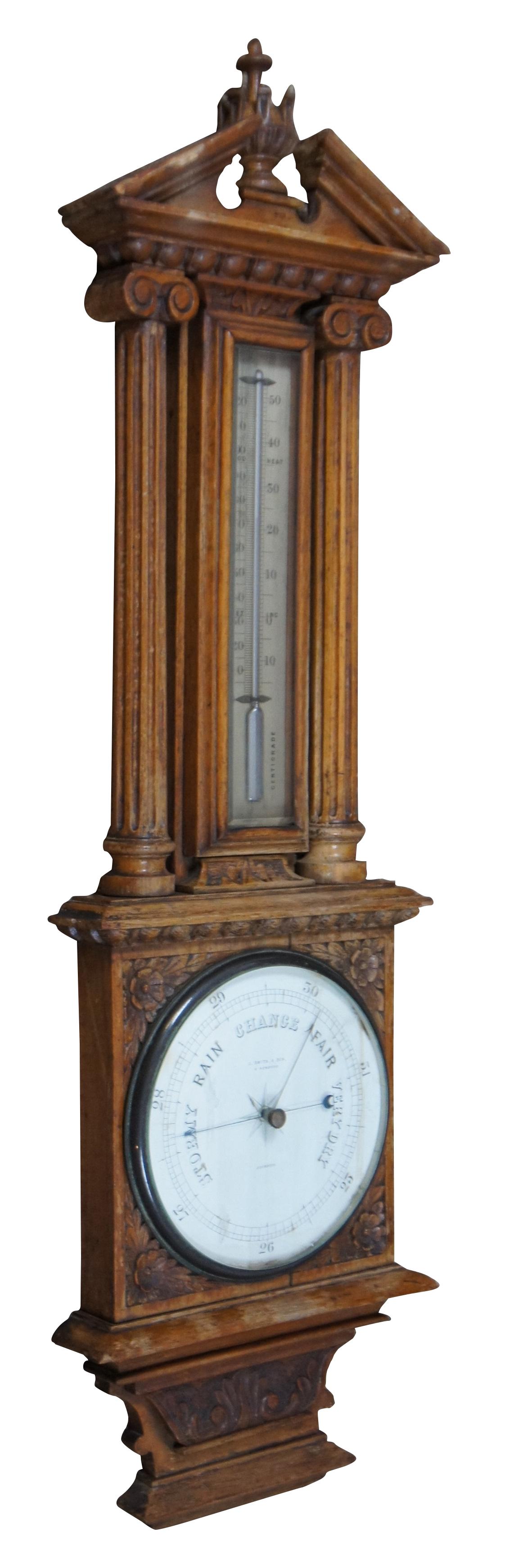 A rare and impressive early 19th century Englsih wall hanging aneroid barometer and mercury thermometer. Perfectly housed in a Neoclassical inspired carved oak case with open pediment over columns. The case features beautiful carvings of acanthus,