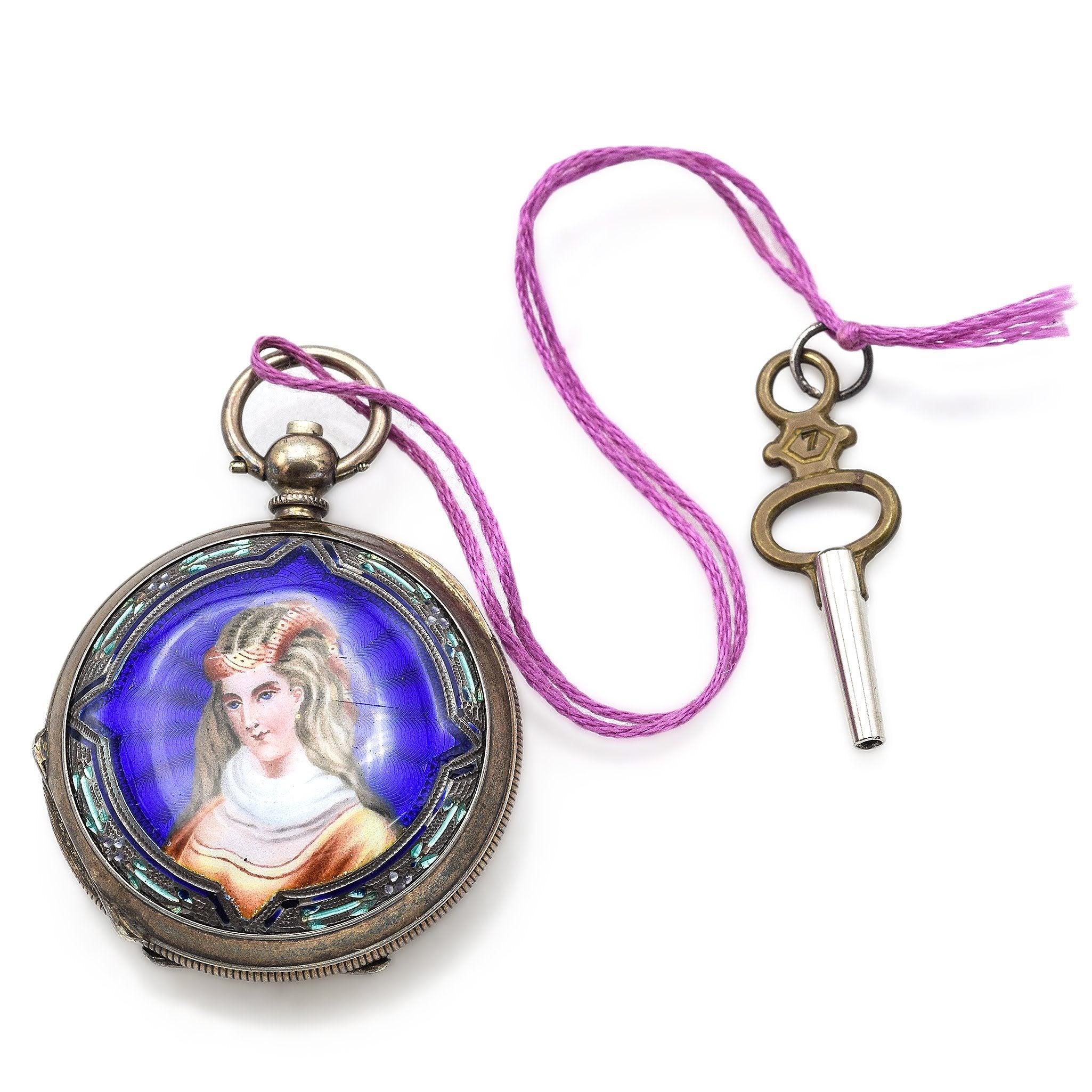 This Antique J. Ullmann & Co. Enamel Pocket Watch showcases exquisite double-sided enamel artwork, featuring hand-painted portraits of a woman. The vibrant blue background contrasts beautifully with the intricate details. J. Ullmann & Co., based in