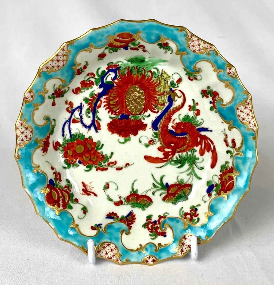 This is a First Period Worcester teacup and saucer painted in the fabulous Jabberwocky pattern.
It is painted in the Kakiemon style.
The cup and saucer both have striking turquoise rococo borders with gilt and iron red diapered panels.
Both have a