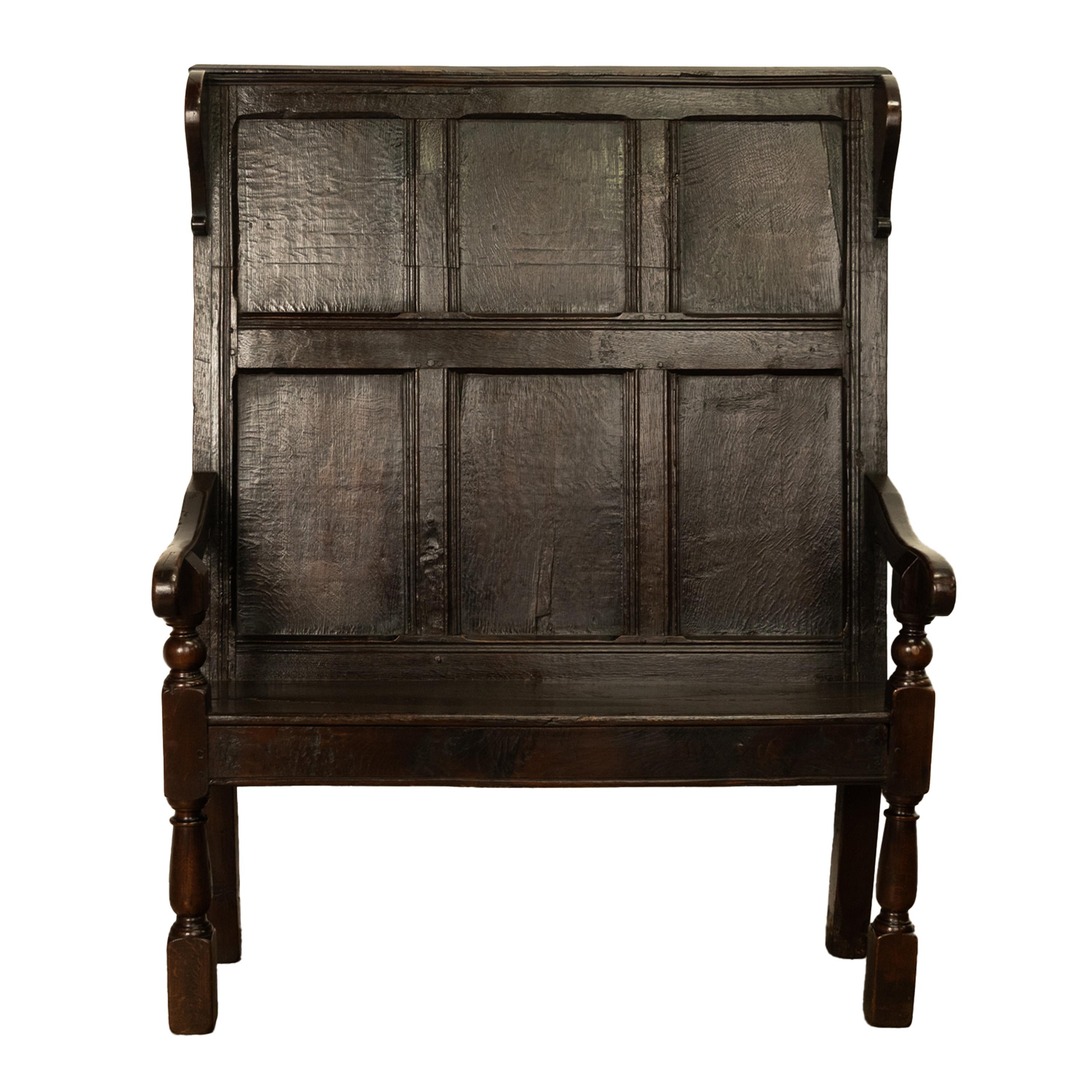 A rare antique oak settle from the Reign of King James I (1603-1625), the settle having provenance from Anne Hathaway's (Shakespeare's wife) cottage, Stratford-upon-Avon.
A tall back, yet diminutive Jacobean oak settle, the six panel back having