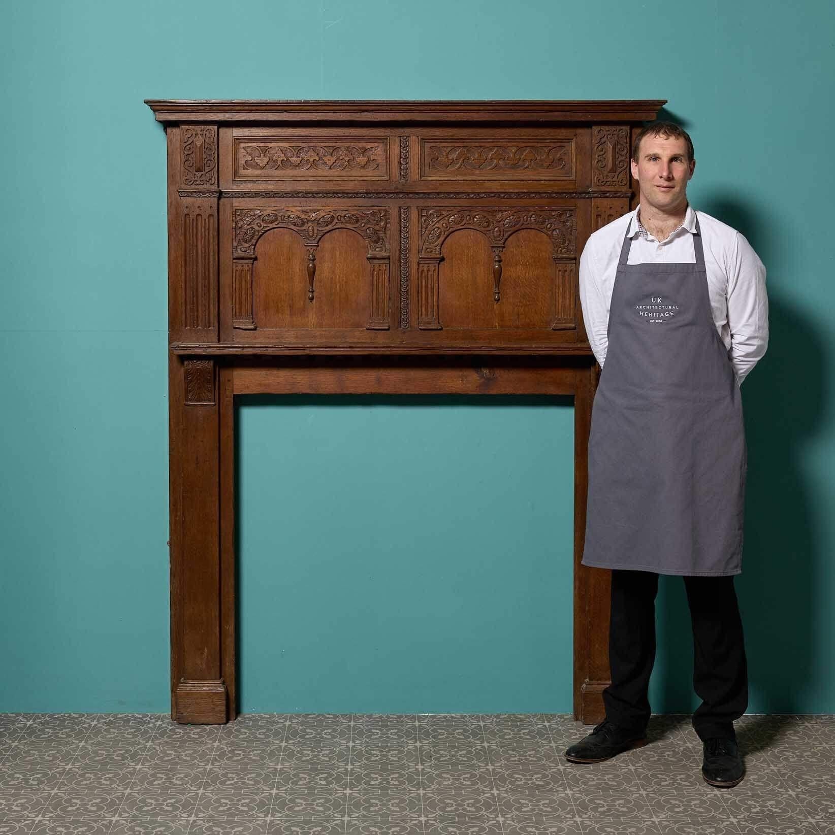 A tall antique English Jacobean style fire surround dating from the Victorian era, constructed from earlier period components.

This large scale, beautifully handcarved fireplace is an impressive chimneypiece for any period interior thanks to its