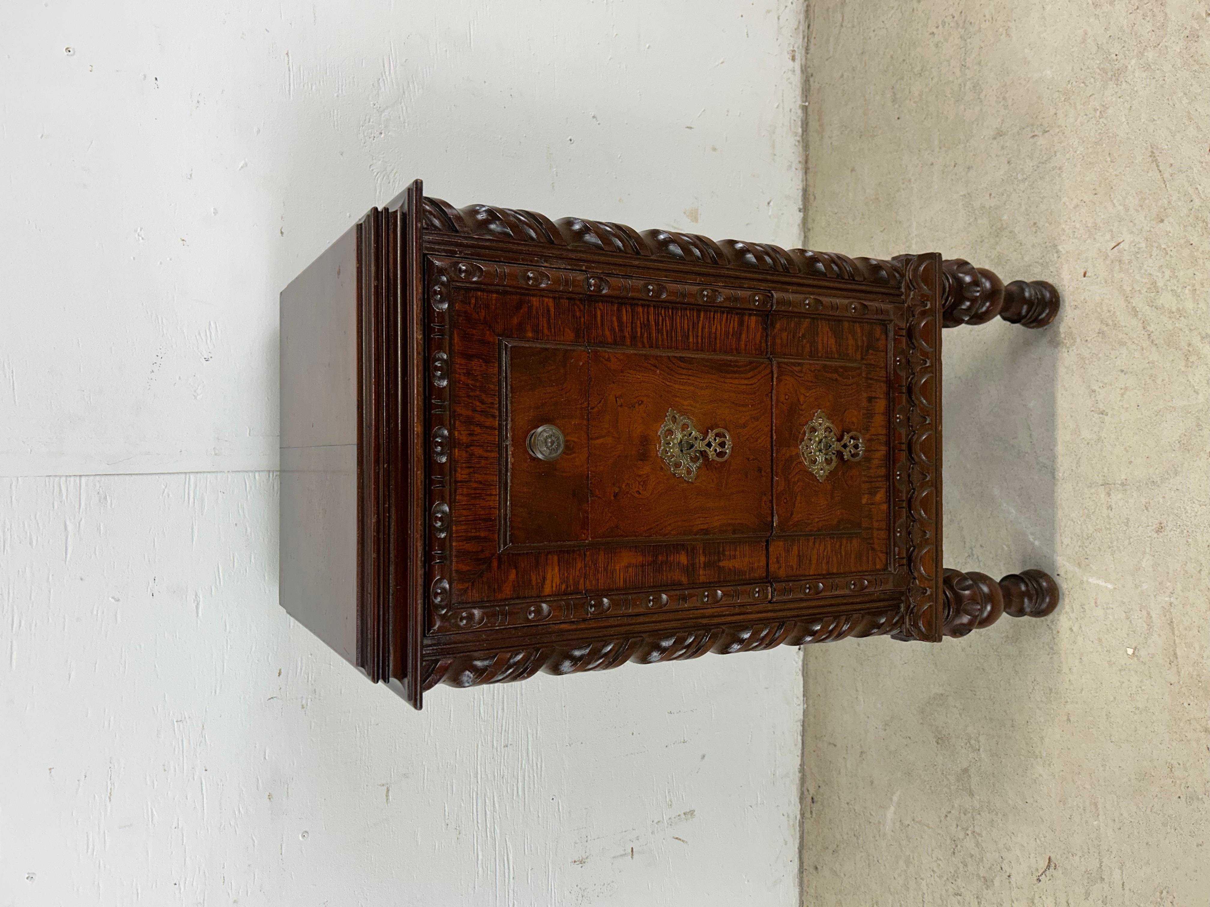 This antique Jacobean style chest features hardwood construction, original finish, unique carved walnut details on trim and legs, and three dovetailed drawers with brass hardware. 

Dimensions: 15w 15d 30.5h

Condition notes: Original finish is in