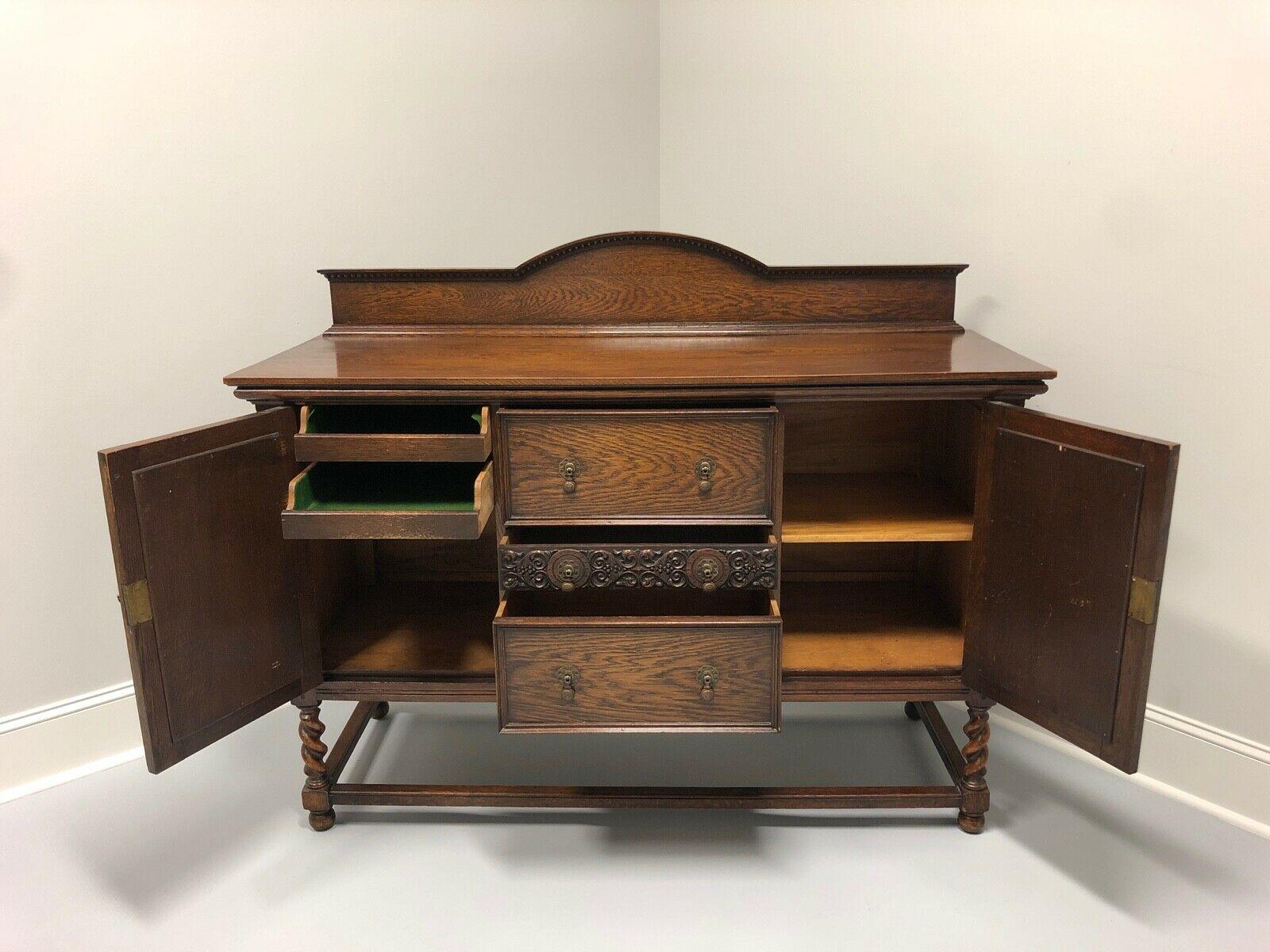 A sideboard in Jacobean style in solid Oak. Likely American in origin from the late 19th to early 20th Century. Carved details with barley twist legs. Three dovetail drawers flanked by two locking cabinets.

Measures: 60W 22.5D 39H, Backsplash