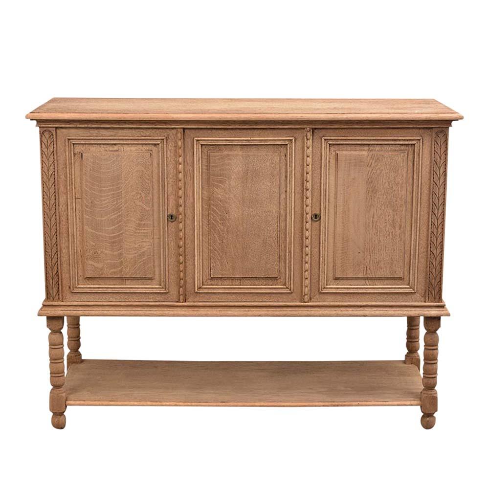 This antique Jacobian style Server has been fully restored and features a new bleached finish. The server has a wooden top with carved wood molding detail and three-panel doors framed with a carved molding. The door has original locks and key in