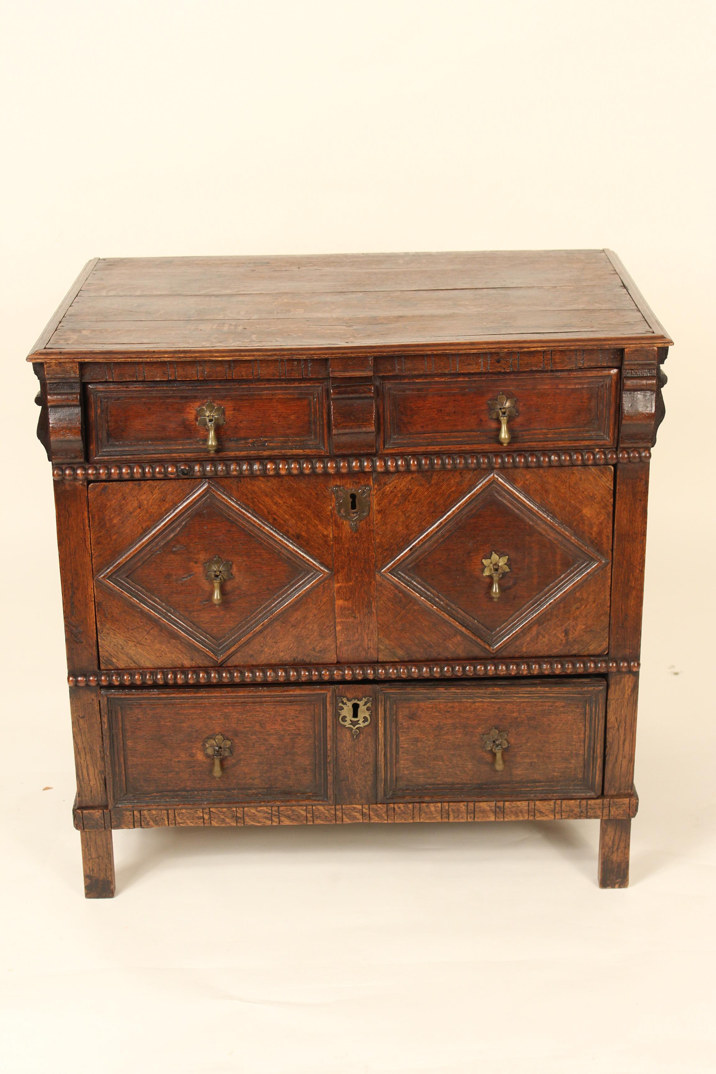 Antique Jacobean style oak chest of drawers, 19th century with restorations.