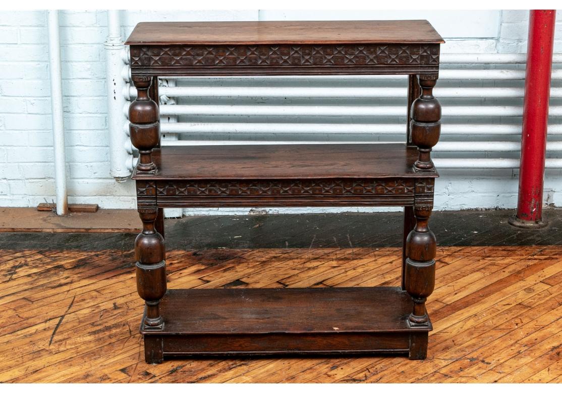 A tiered Jacobean Server with bold form, great age patina and three tiers. Made in three tiers, the top and second tier with carved friezes in a pattern of textured squares and small rosettes. With heavy carved turned supports on the front and
