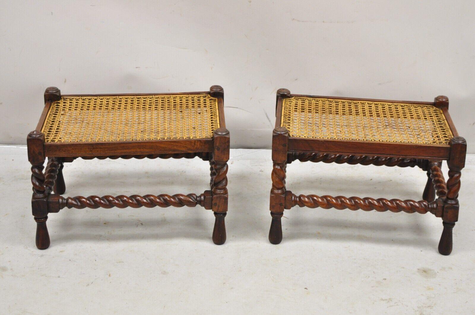 Antique Jacobean Turn Carved Spiral Twist Walnut Handmade Cane Seat Footstool Ottoman - Pair. Item features hand woven cane seats, beautiful wood grain, very nice complimentary pair (one stool is slightly larger than the other) Circa  19th