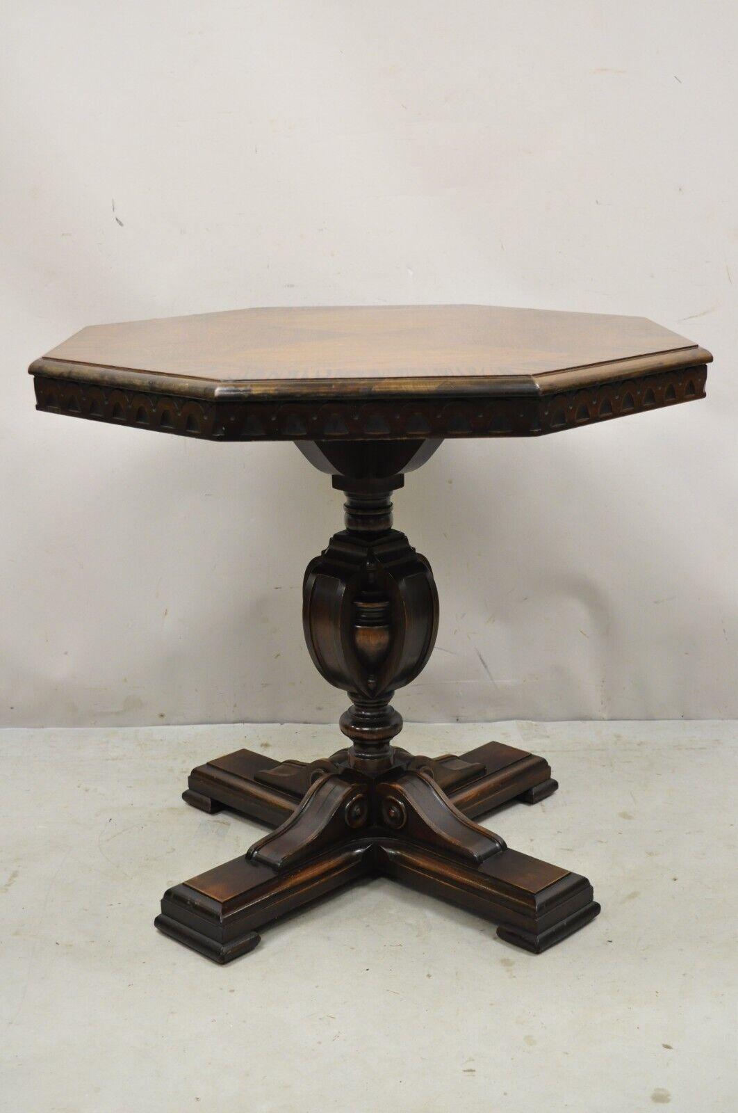 Antique Jacobean Walnut Banded Inlay Sunburst Top Octagonal Center Table. Item features carved pedestal bases, banded inlay sunburst top, zebra wood border, beautiful wood grain, nicely carved details, very nice antique item, great style and form.